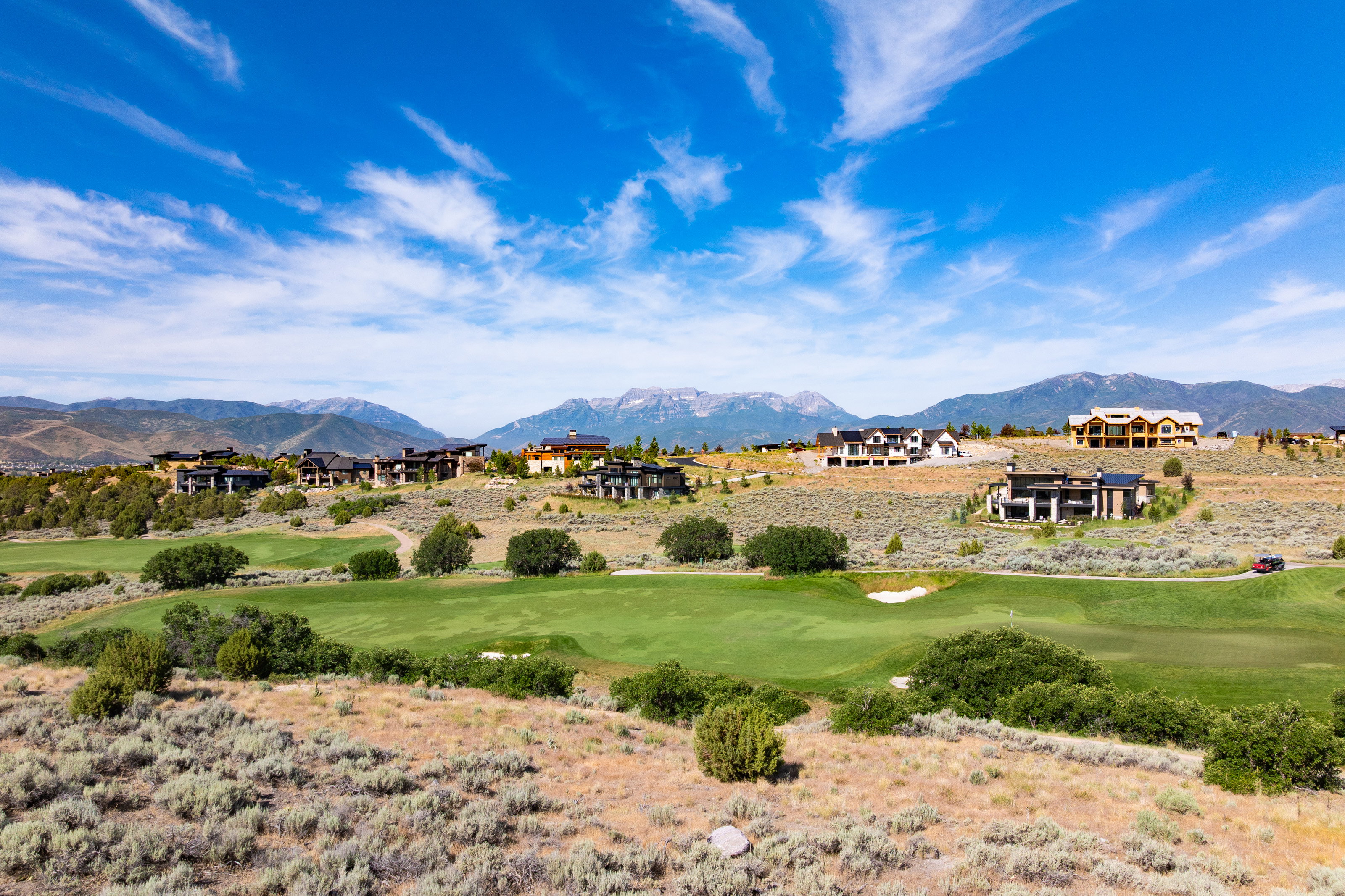 Expansive golf course frontage with manicured fairways and natural landscaping