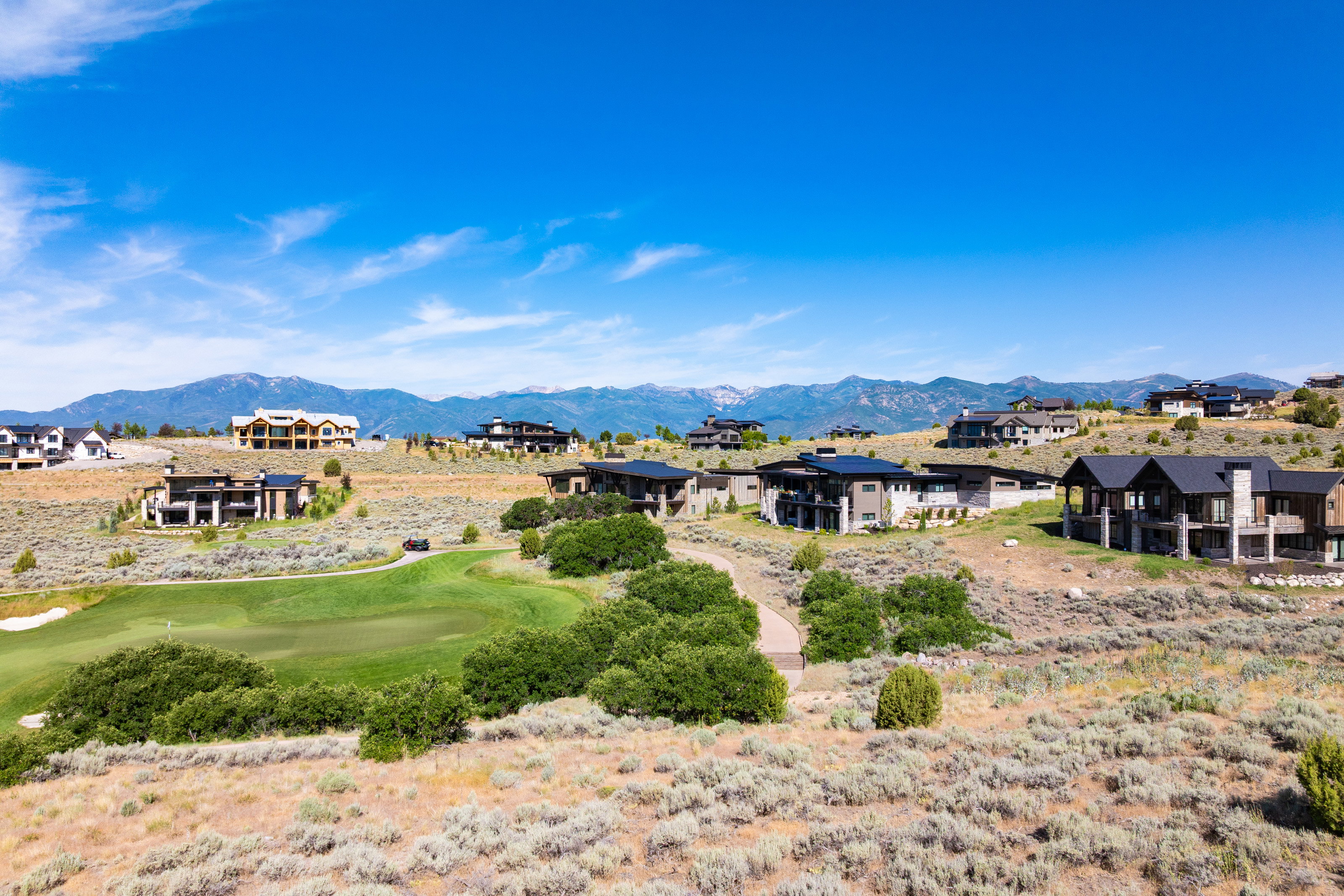 Expansive properties featuring varied contemporary architectural styles, integrated into a natural, elevated landscape