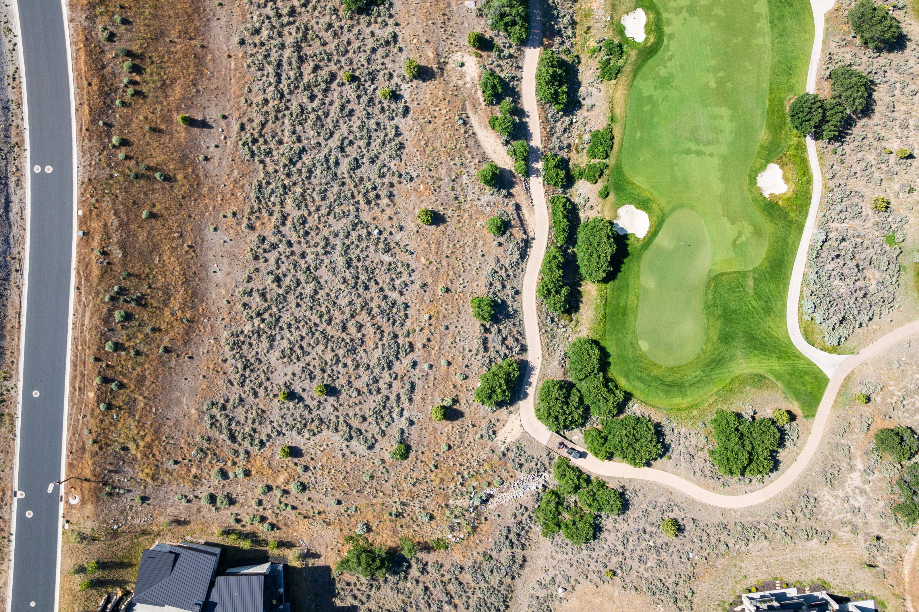 Aerial perspective showcasing a verdant golf course with sand traps and cart paths