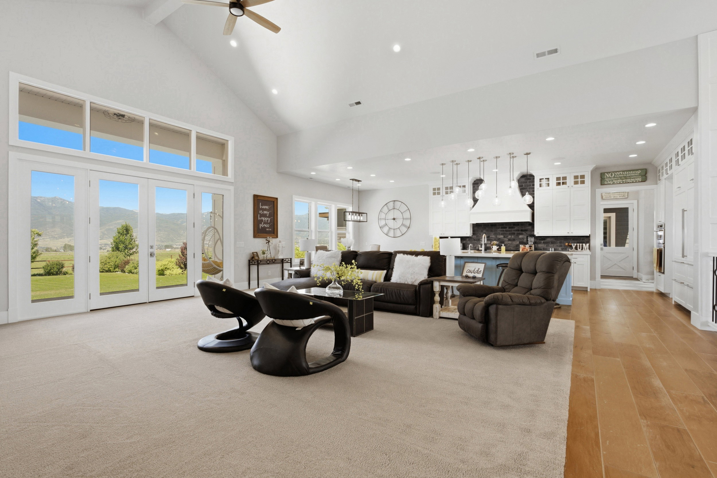 Open-concept living space featuring vaulted ceilings, a ceiling fan, and recessed lighting