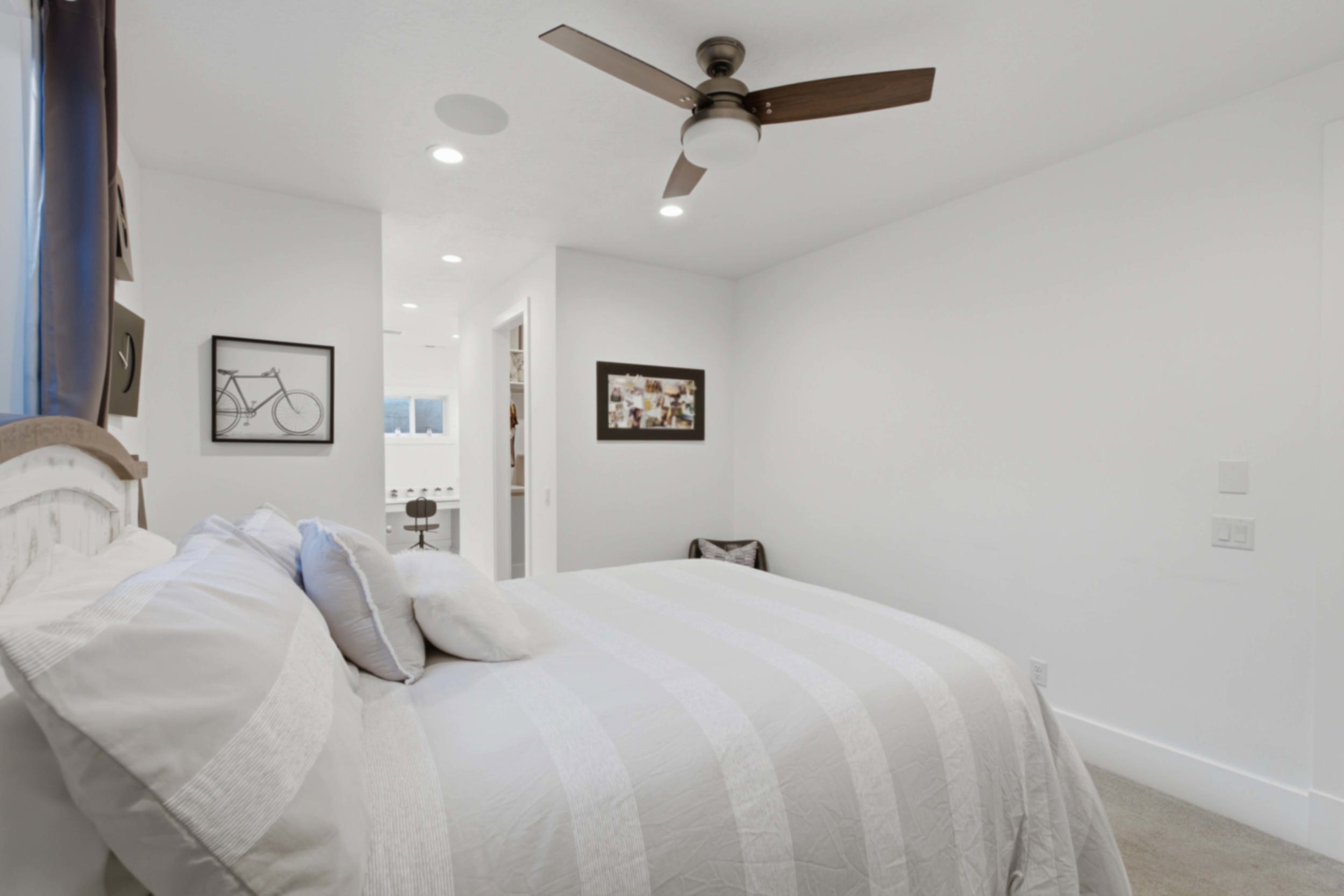 Spacious room featuring a ceiling fan, recessed lighting, and a neutral color palette