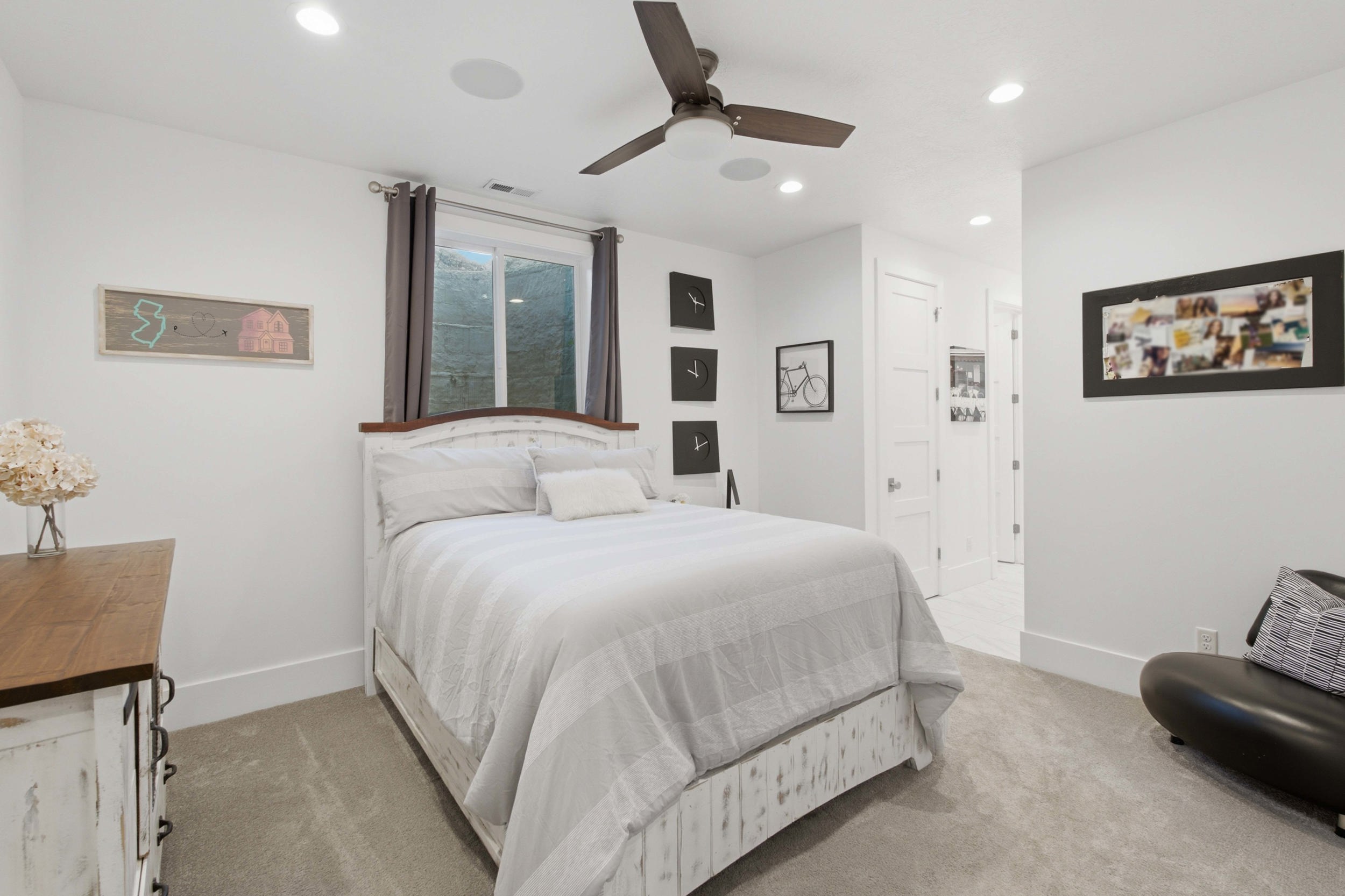 Bedroom featuring a window with privacy curtains, recessed lighting, and a ceiling fan