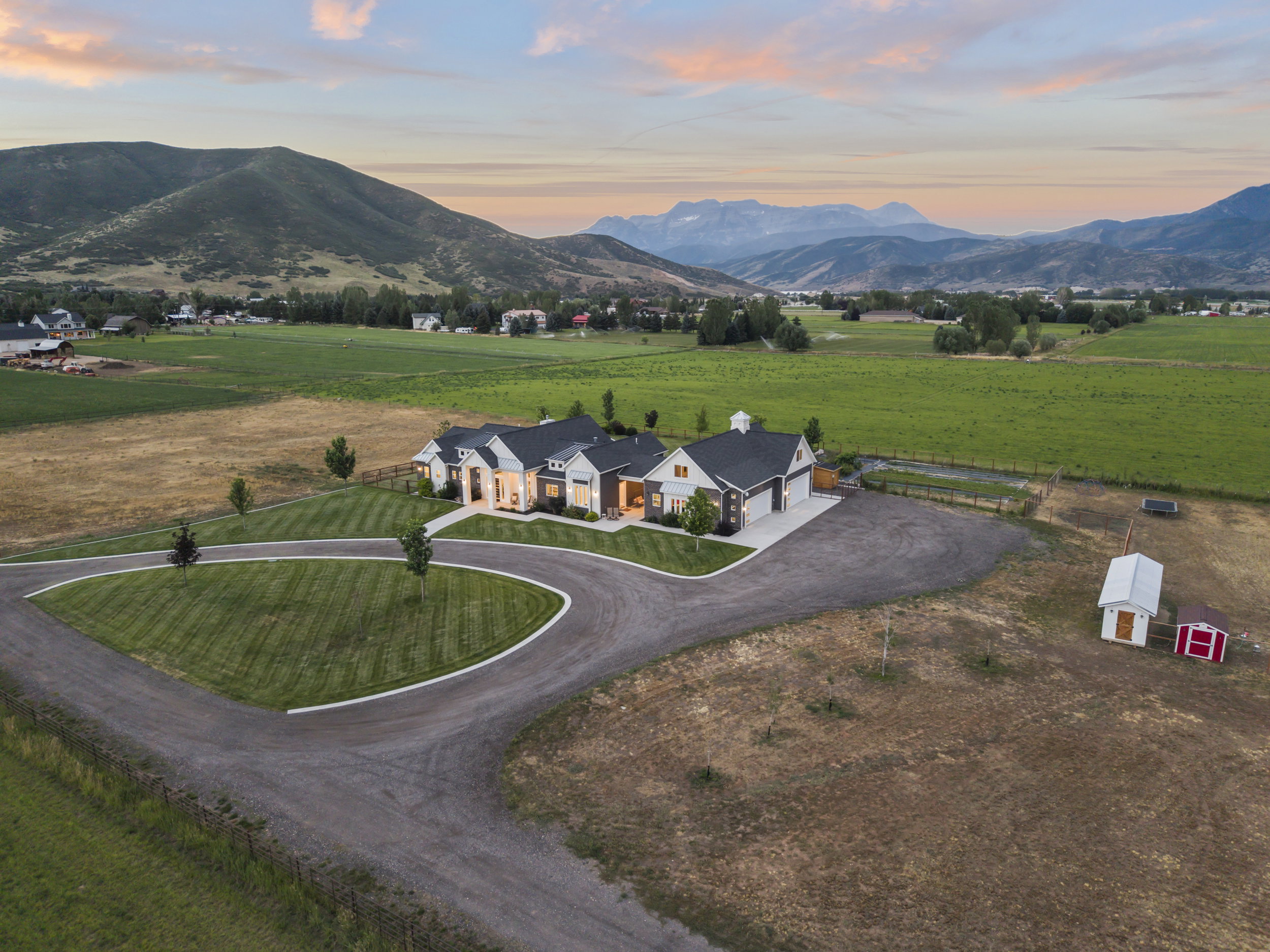 Expansive estate featuring a large main residence, circular drive, and substantial acreage