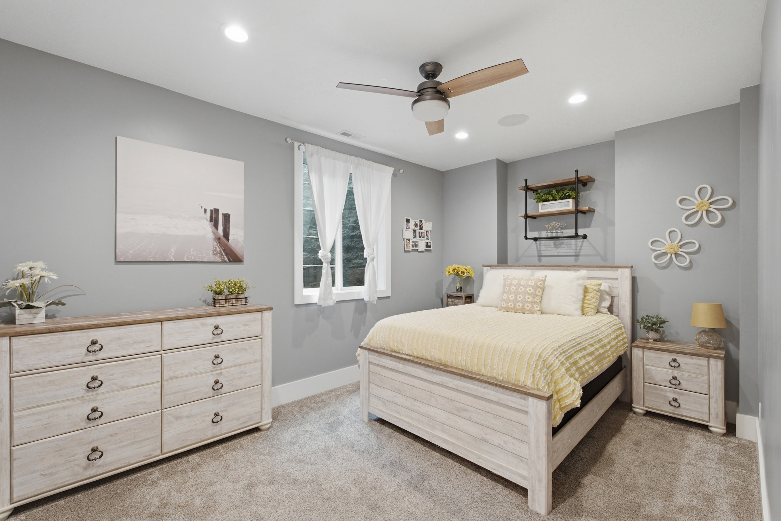 Bedroom with neutral gray walls and light-toned carpeting
