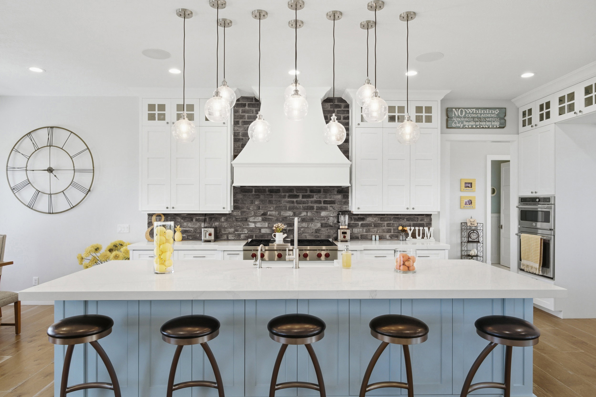 Expansive kitchen island featuring a light blue shiplap base and a white countertop