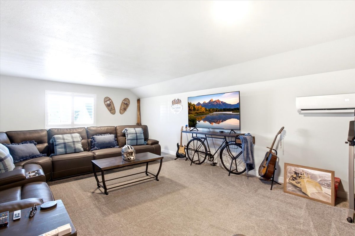 Carpeted living space with a wall-mounted mini-split system