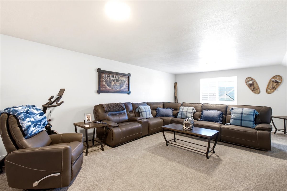 Spacious upper level  bonus room featuring light-toned walls, recessed lighting, and carpet flooring
