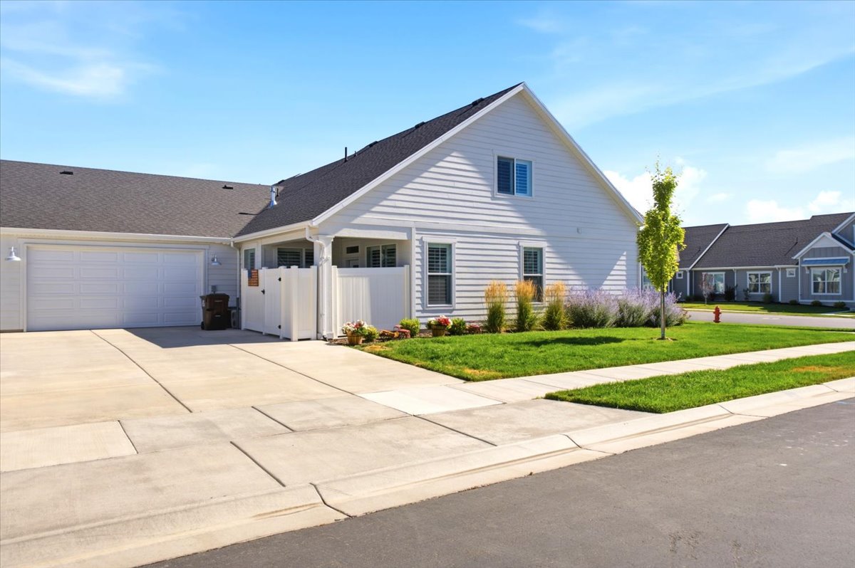White horizontal siding exterior with a dark shingle roof