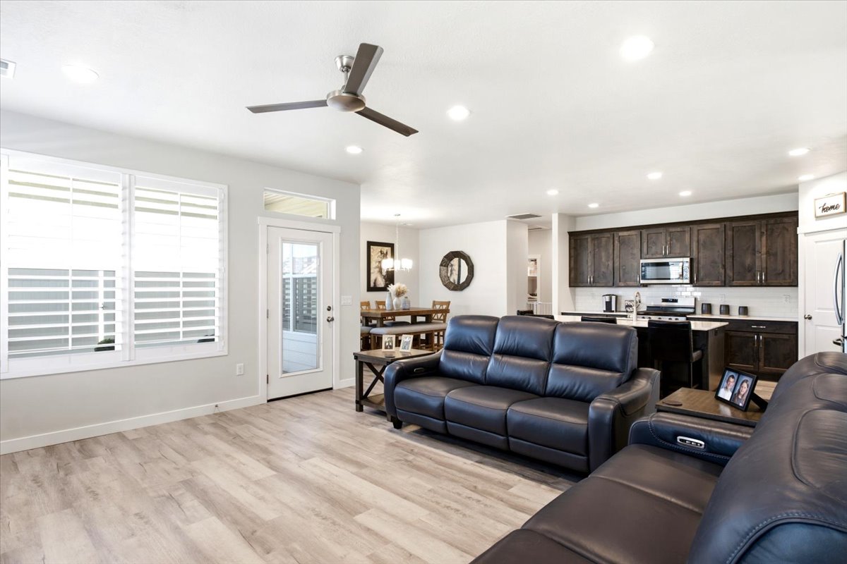 Open-concept living area featuring wood-finish flooring, recessed lighting, and a ceiling fan