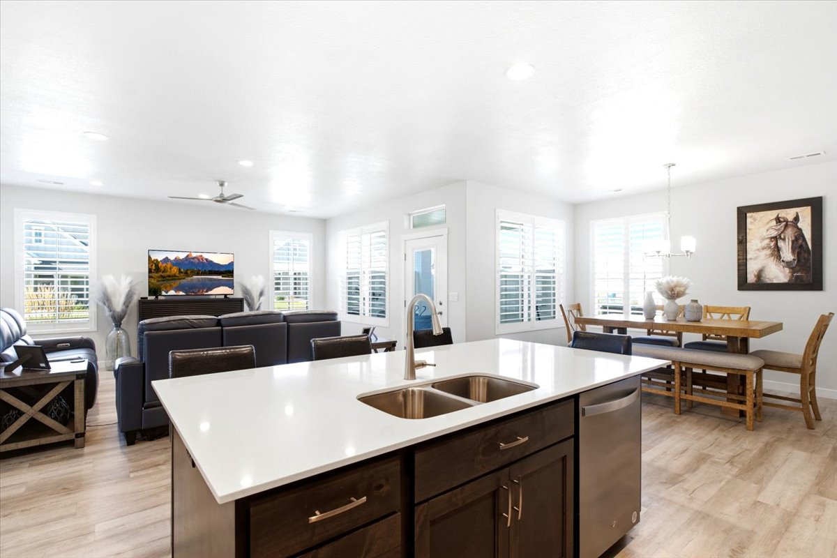 Central kitchen island with a double basin sink and stainless steel dishwasher