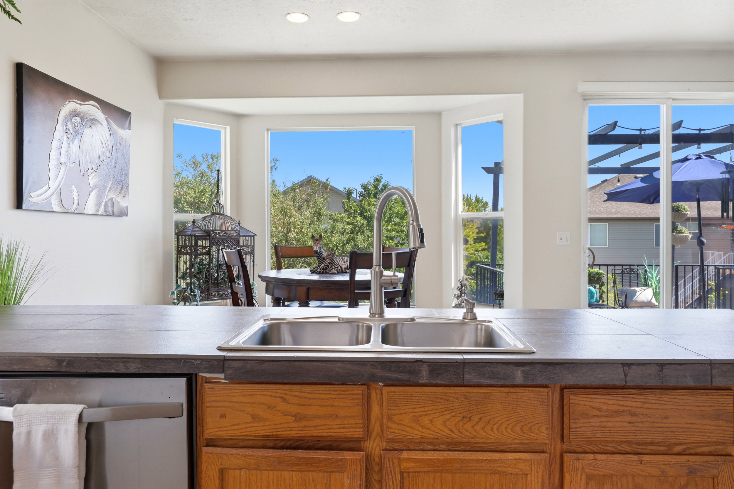 Kitchen island with a double basin stainless steel sink and a gooseneck faucet