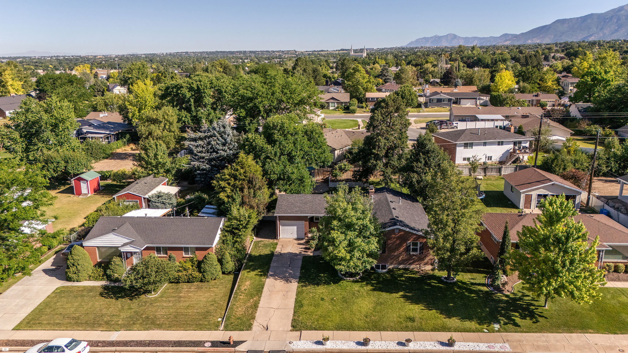 Expansive neighborhood featuring mature trees and mountain scenery