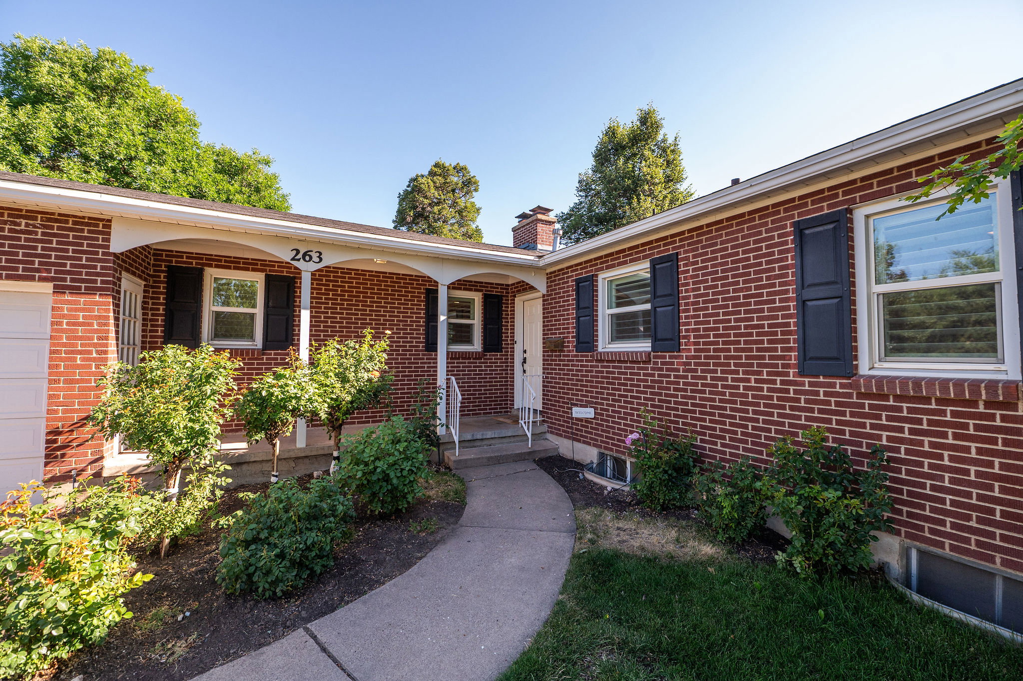 Brick exterior with contrasting dark window shutters