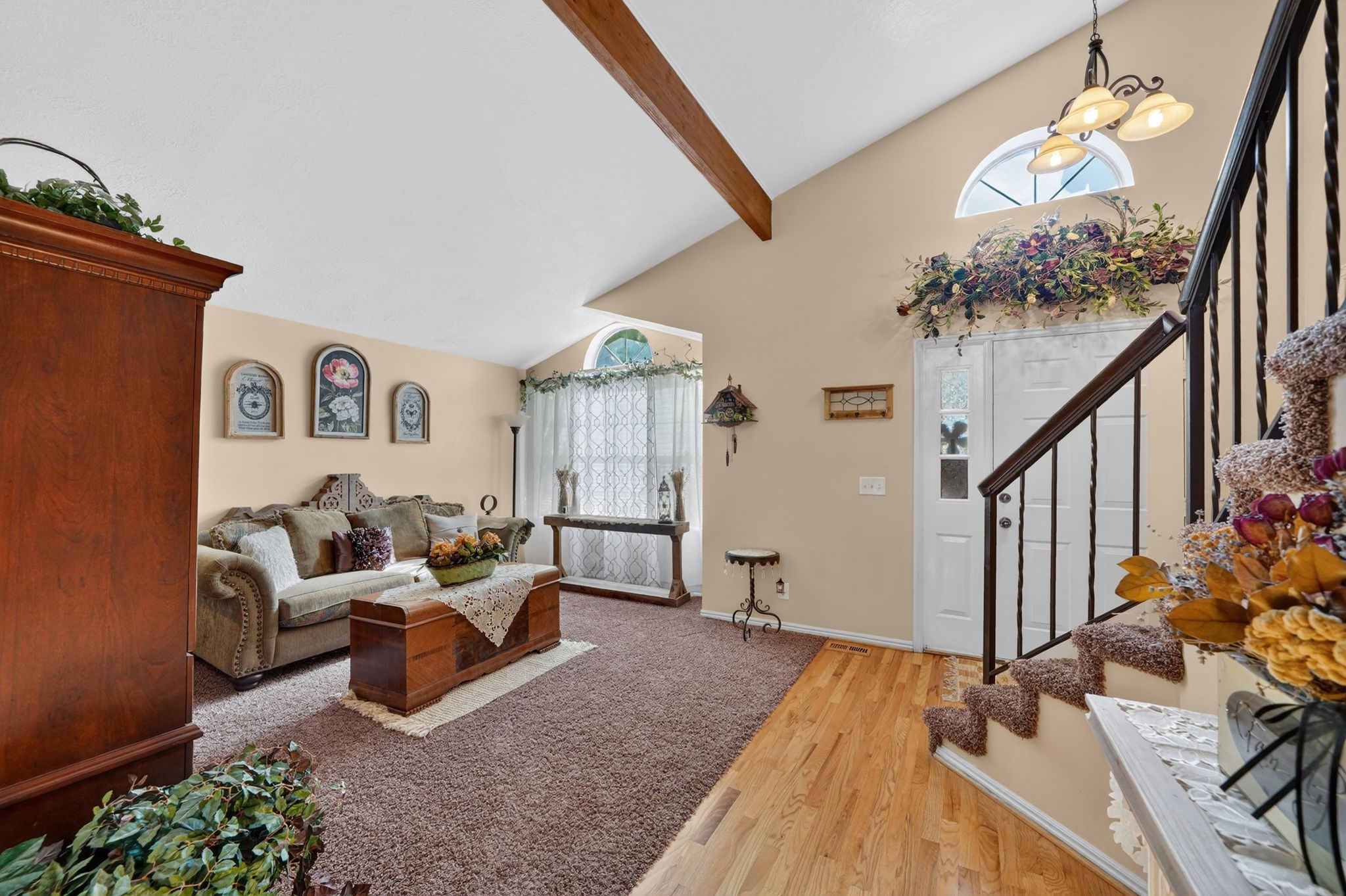 Vaulted ceilings featuring an exposed wood beam