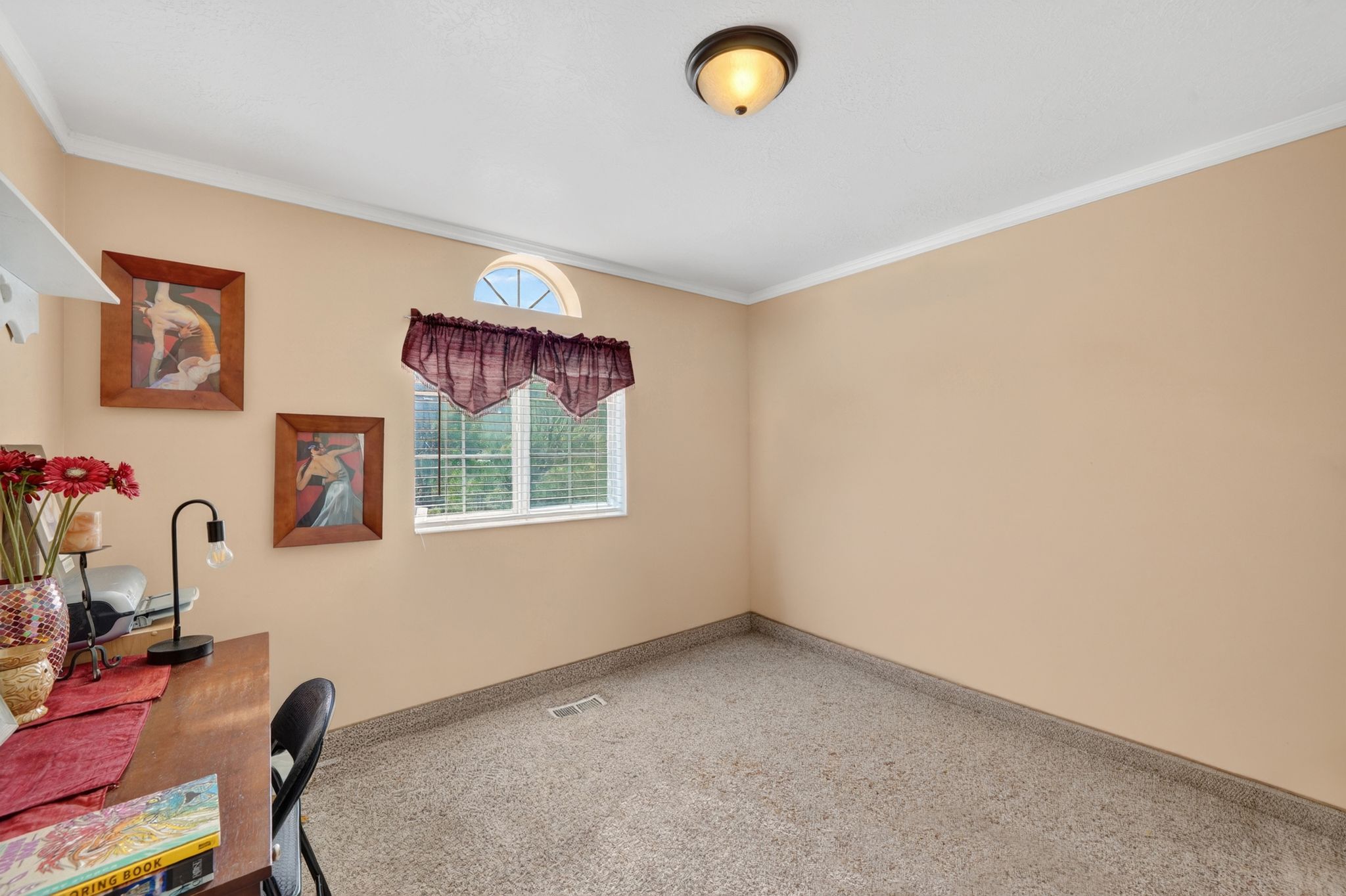 Room featuring a window with a semicircular transom, neutral-toned walls, and a recessed ceiling light