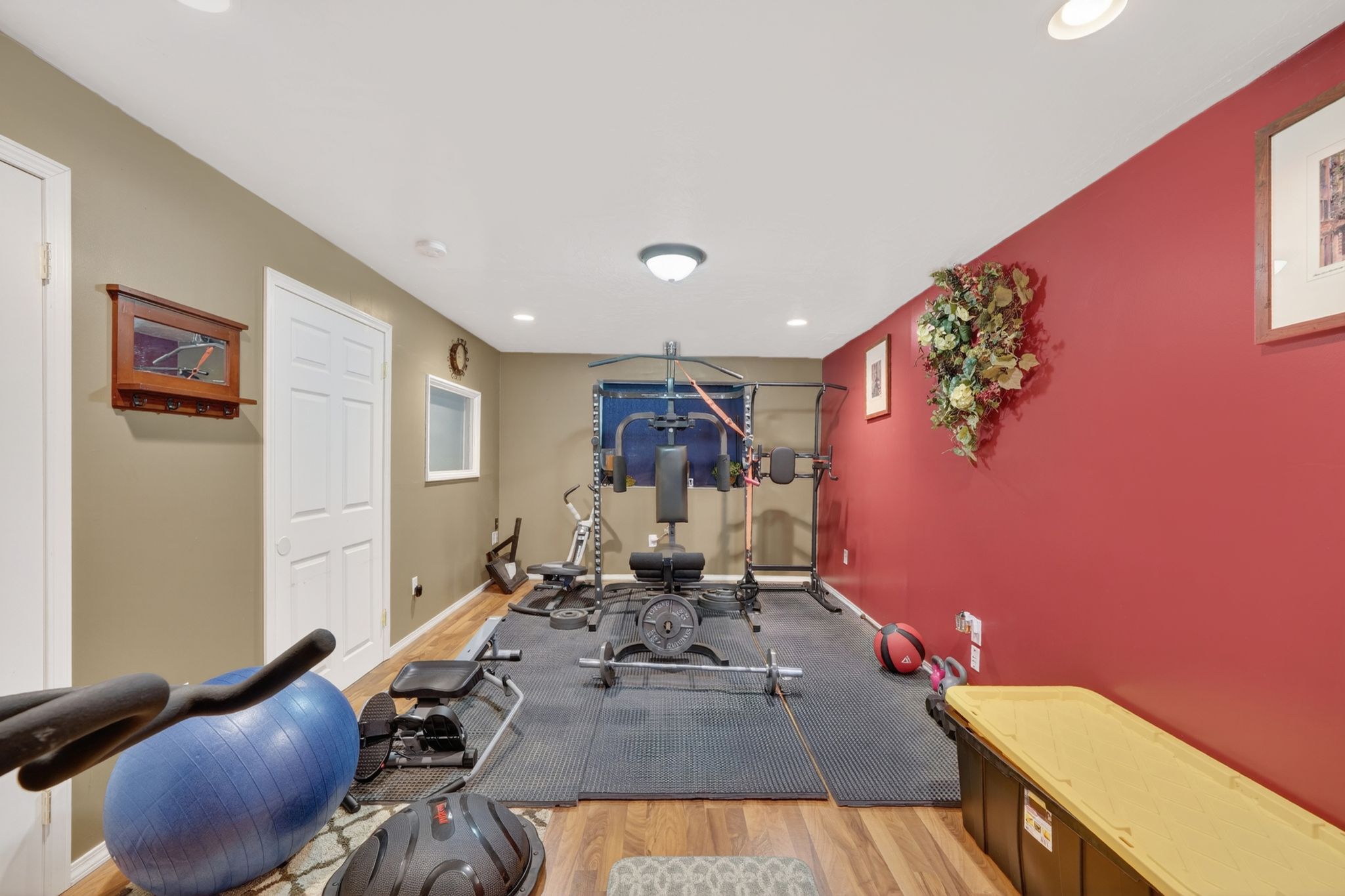 Finished lower level offering wood-finish flooring, recessed lighting, and a window for natural light