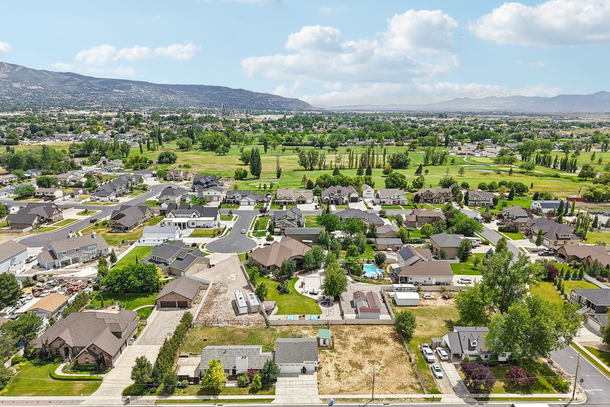 Aerial perspective showcasing a residential neighborhood with a mountain backdrop
