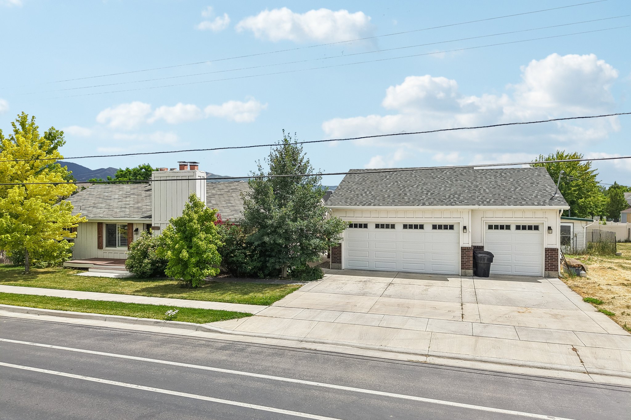 Spacious multi-car garage with white paneled doors and brick accents