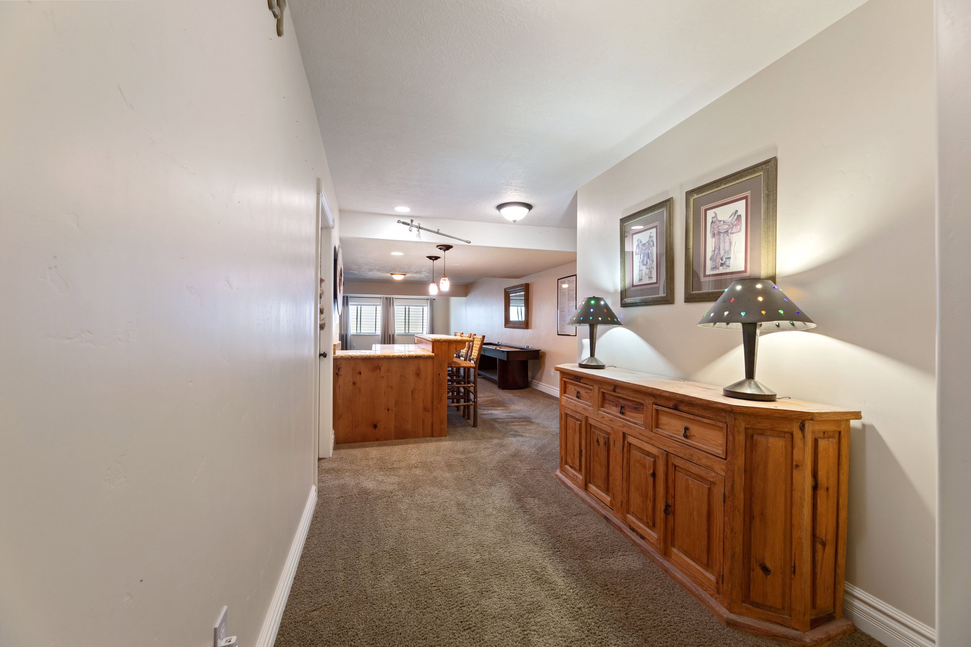 Spacious interior hallway featuring neutral wall tones and carpeted flooring