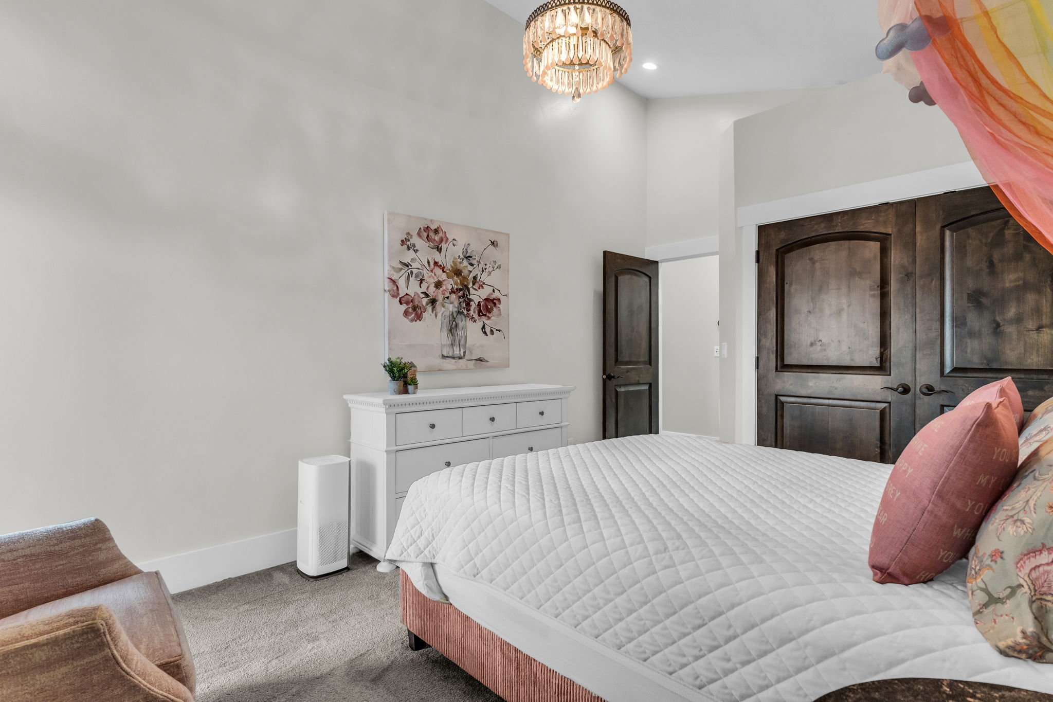 Bedroom featuring high ceilings and dark wood-finish doors