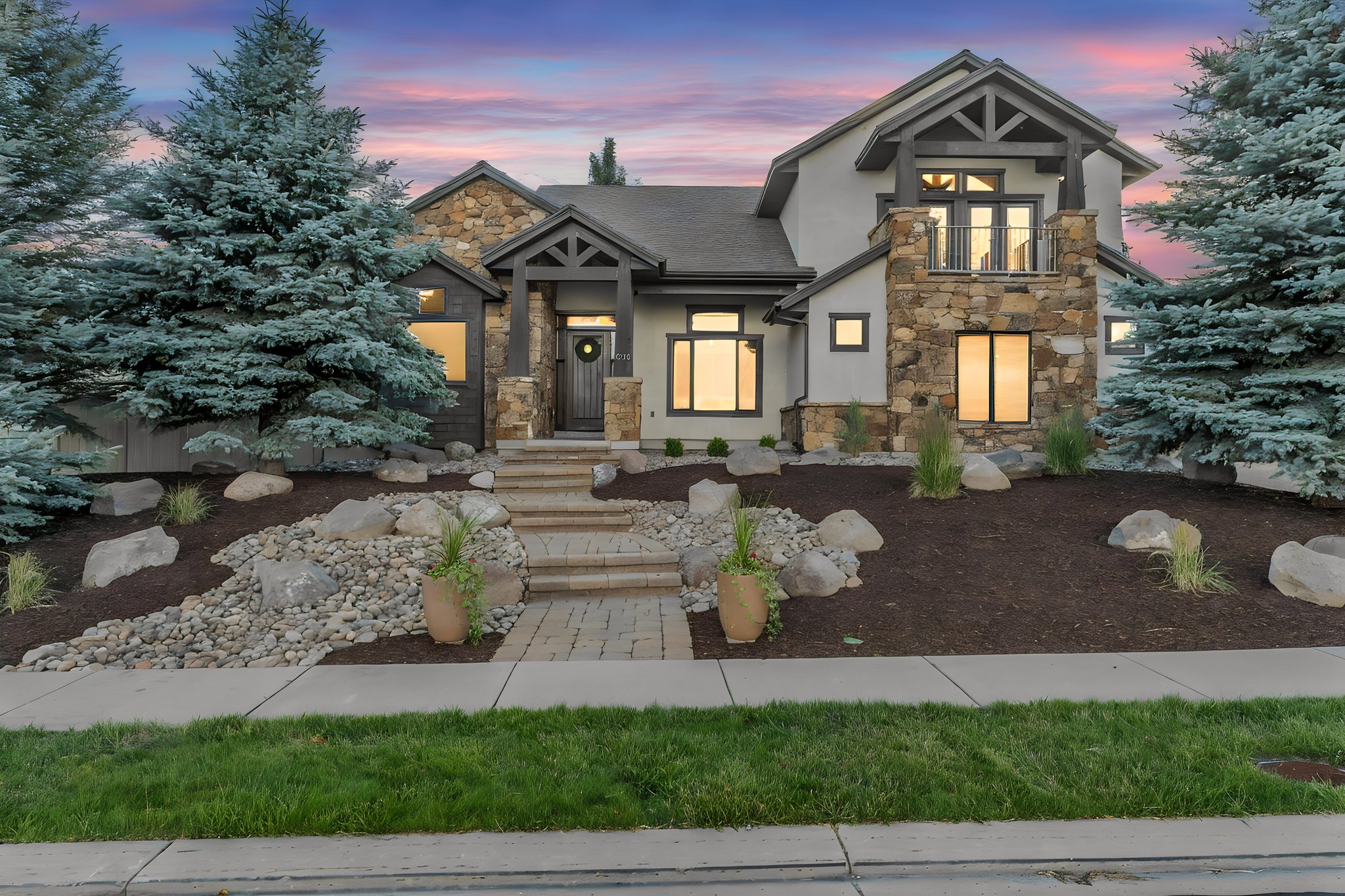 Multi-textured facade featuring stone, stucco, and dark wood accents