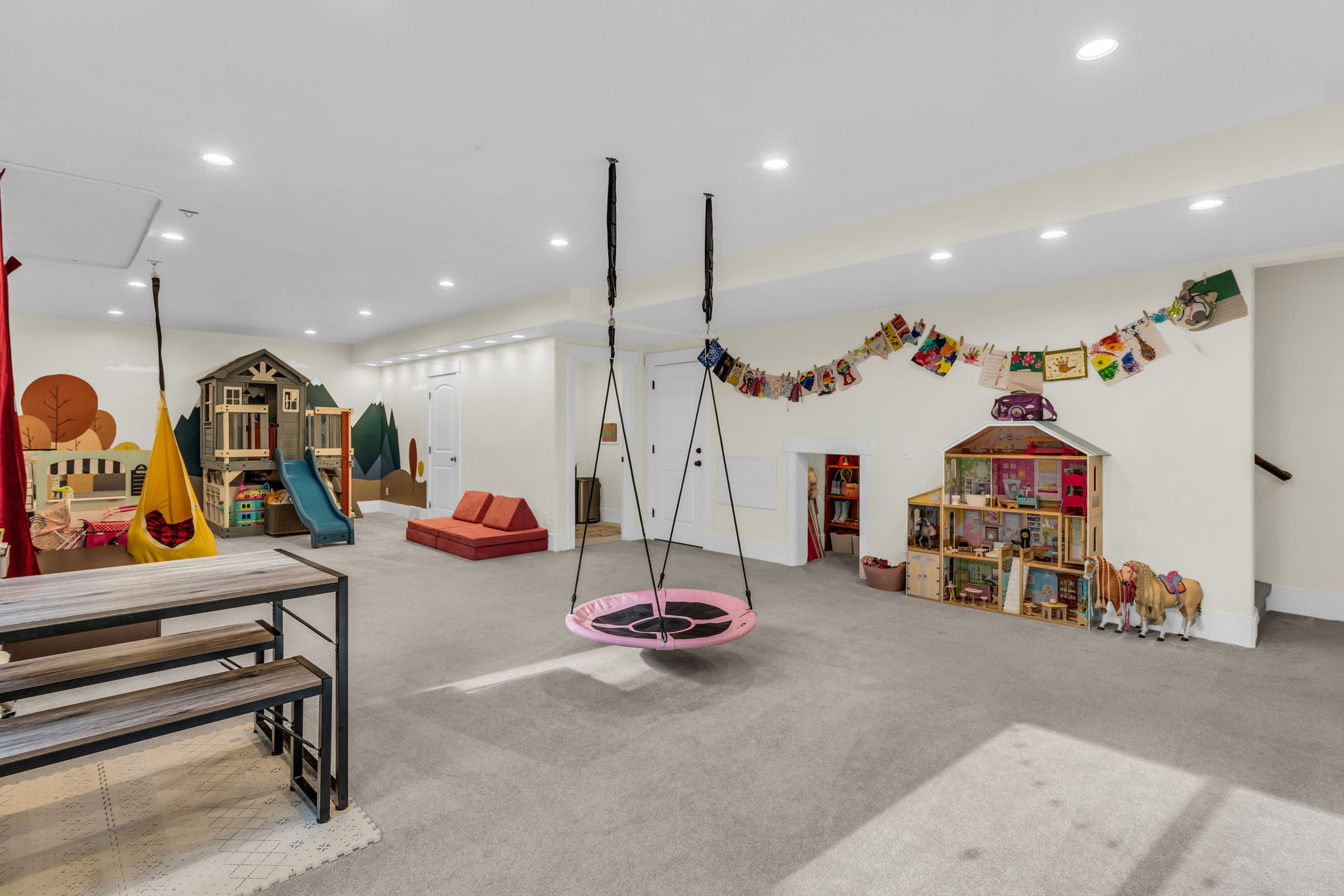 Spacious room featuring light gray carpet flooring and recessed ceiling lights