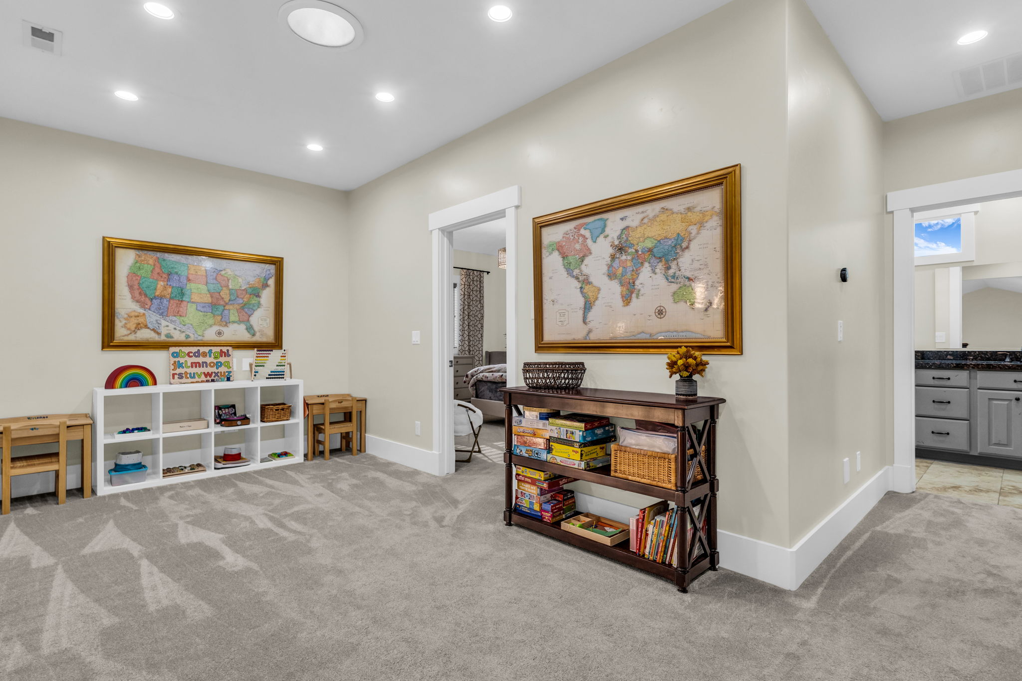 Spacious carpeted room featuring recessed lighting, a built-in shelving unit, and white trim molding