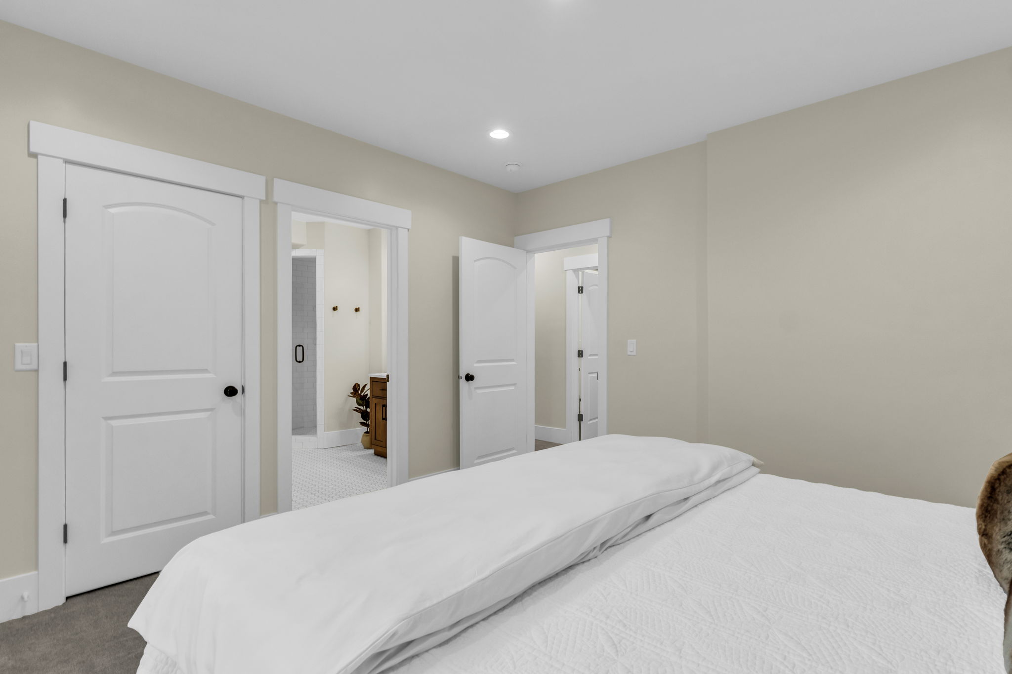 Soft neutral-toned walls complement white trim and doors
