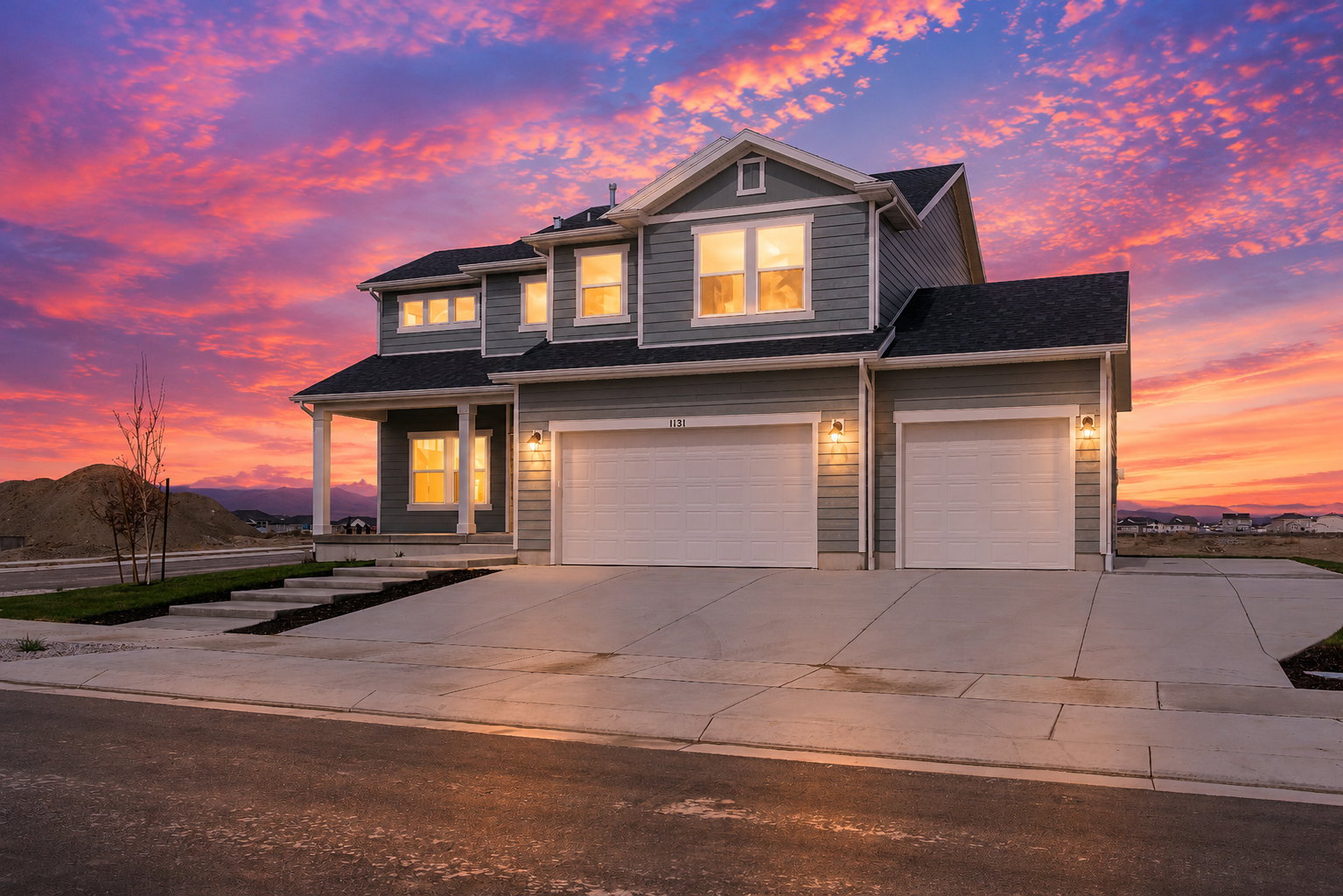 Contemporary two-story residence featuring grey horizontal siding and white trim