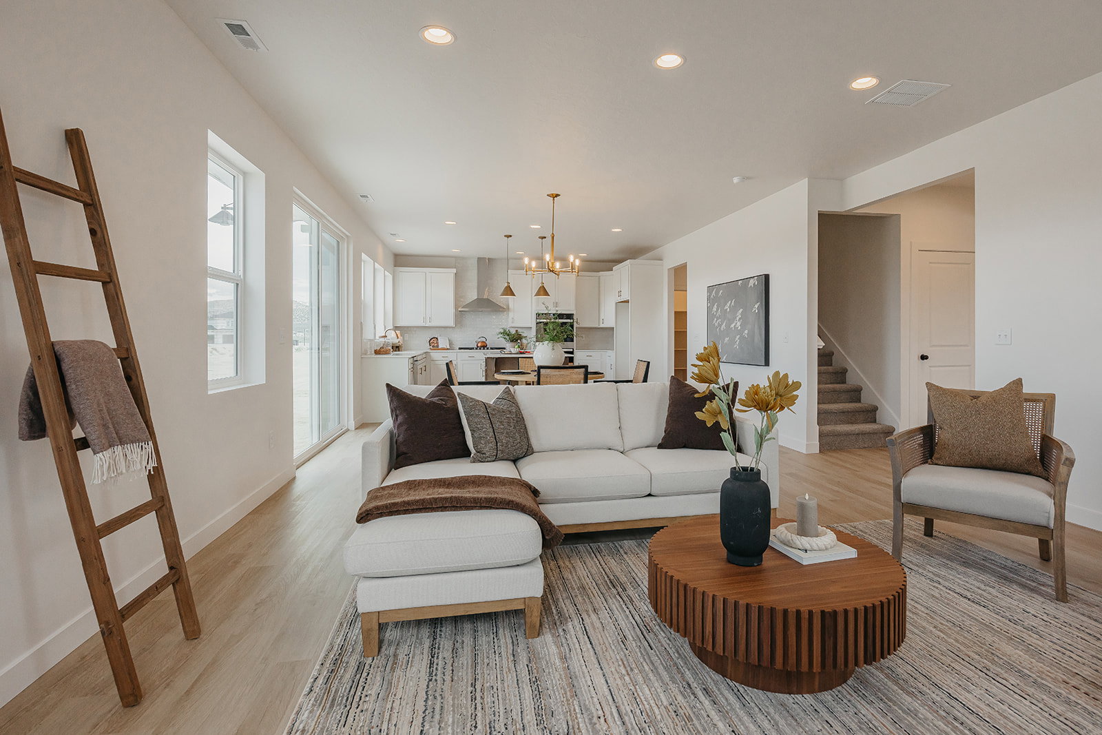 Open-concept living area featuring light wood-finish flooring and recessed lighting