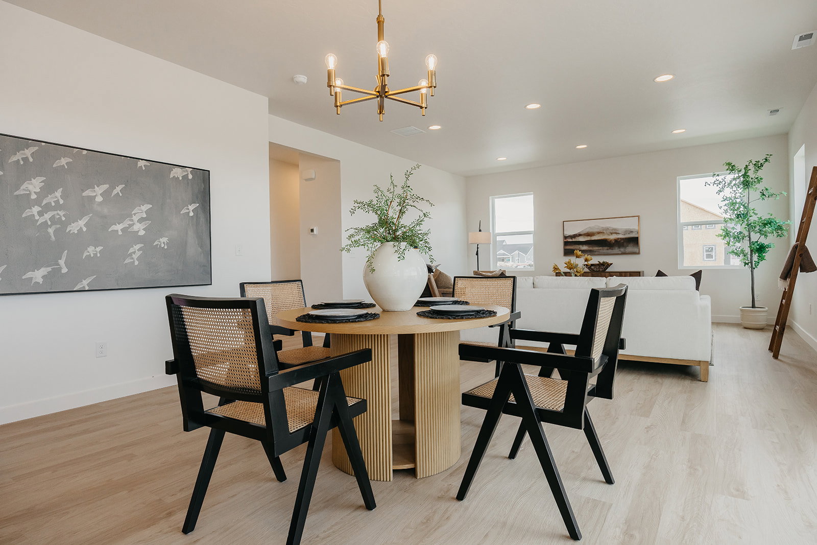 Open-concept living space featuring wood-finish flooring, recessed lighting, and ample natural light from multiple windows