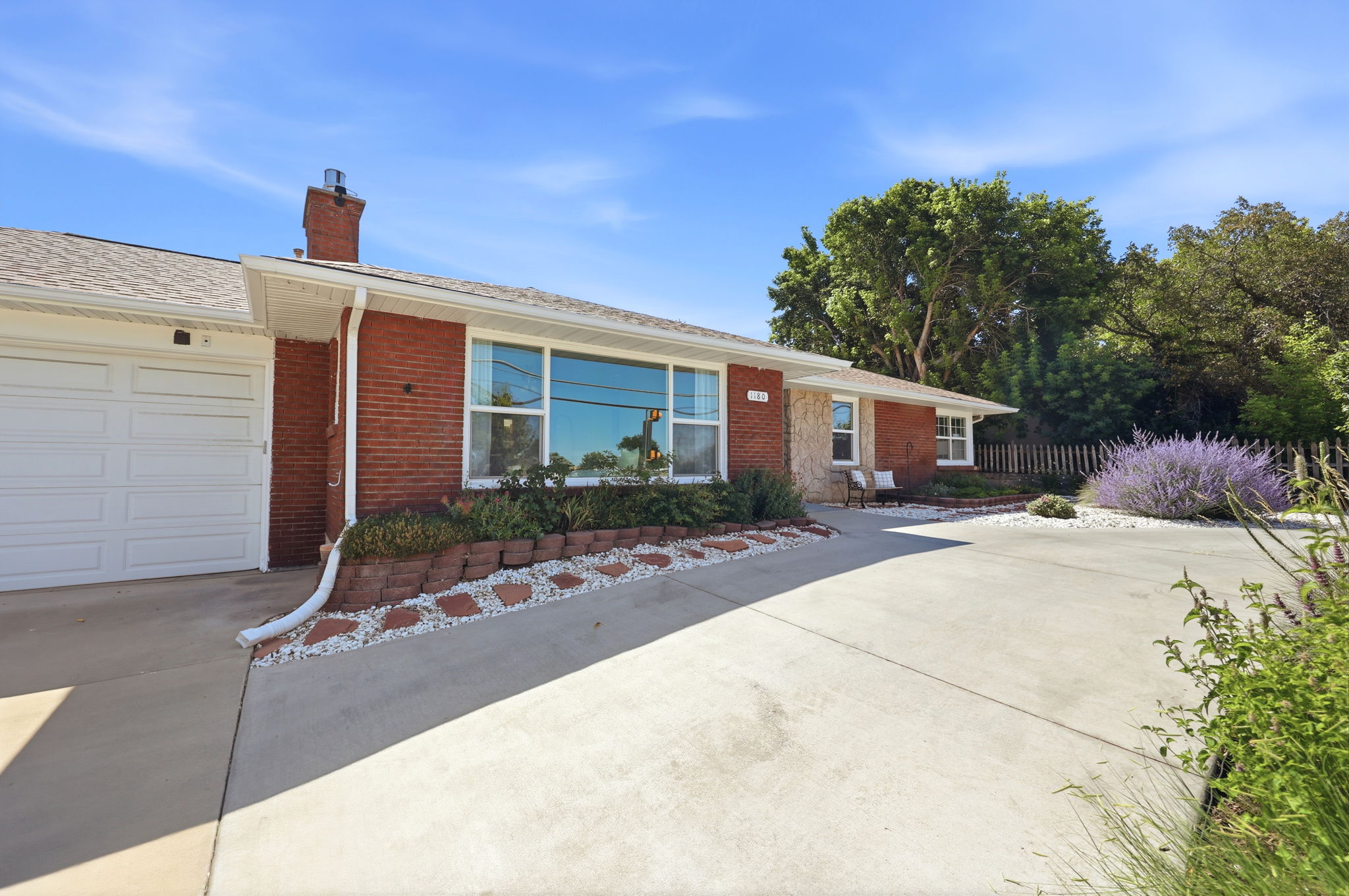 Red brick exterior with a single garage door