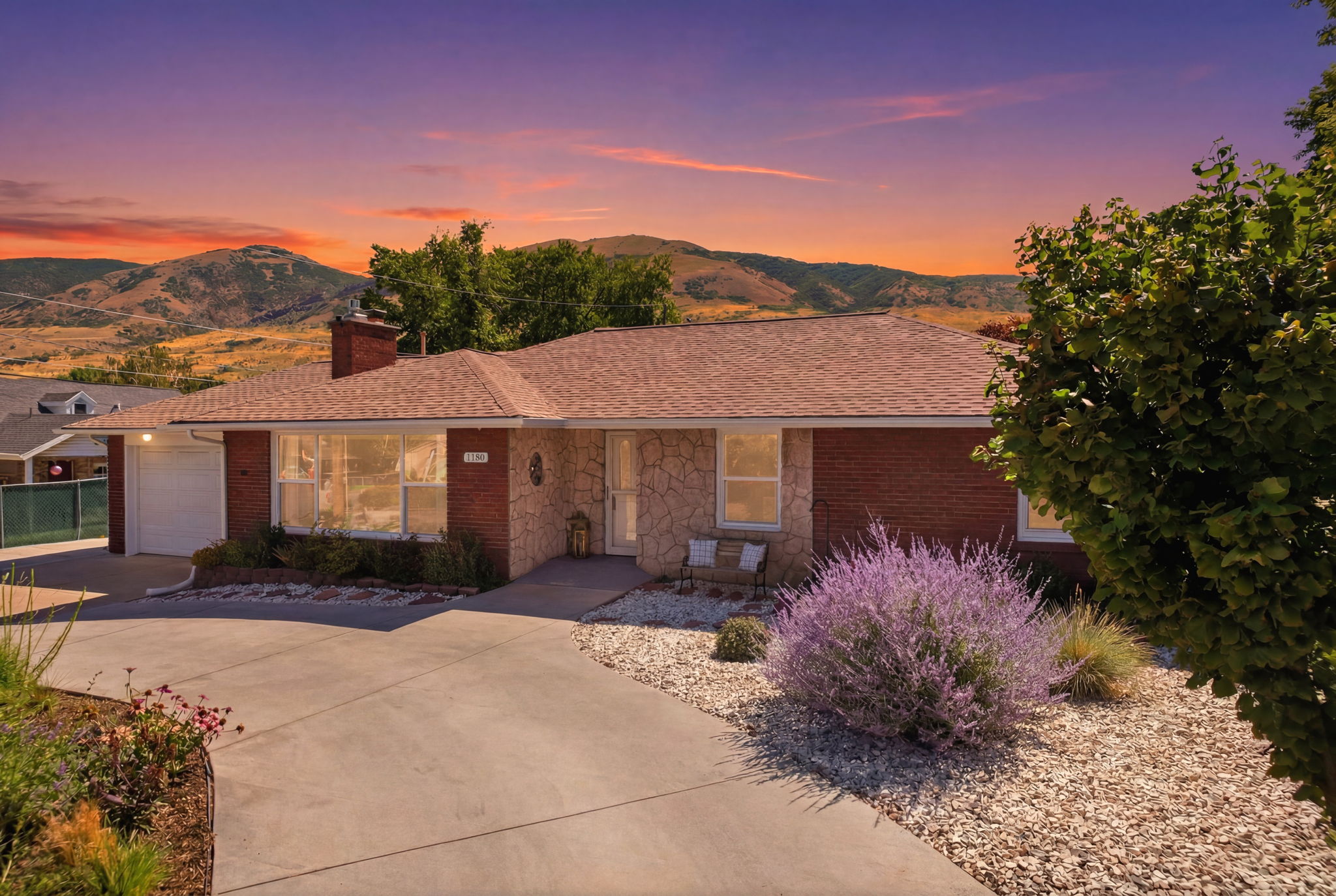 Ranch-style residence featuring brick and stone veneer, a concrete driveway, and an attached two-car garage