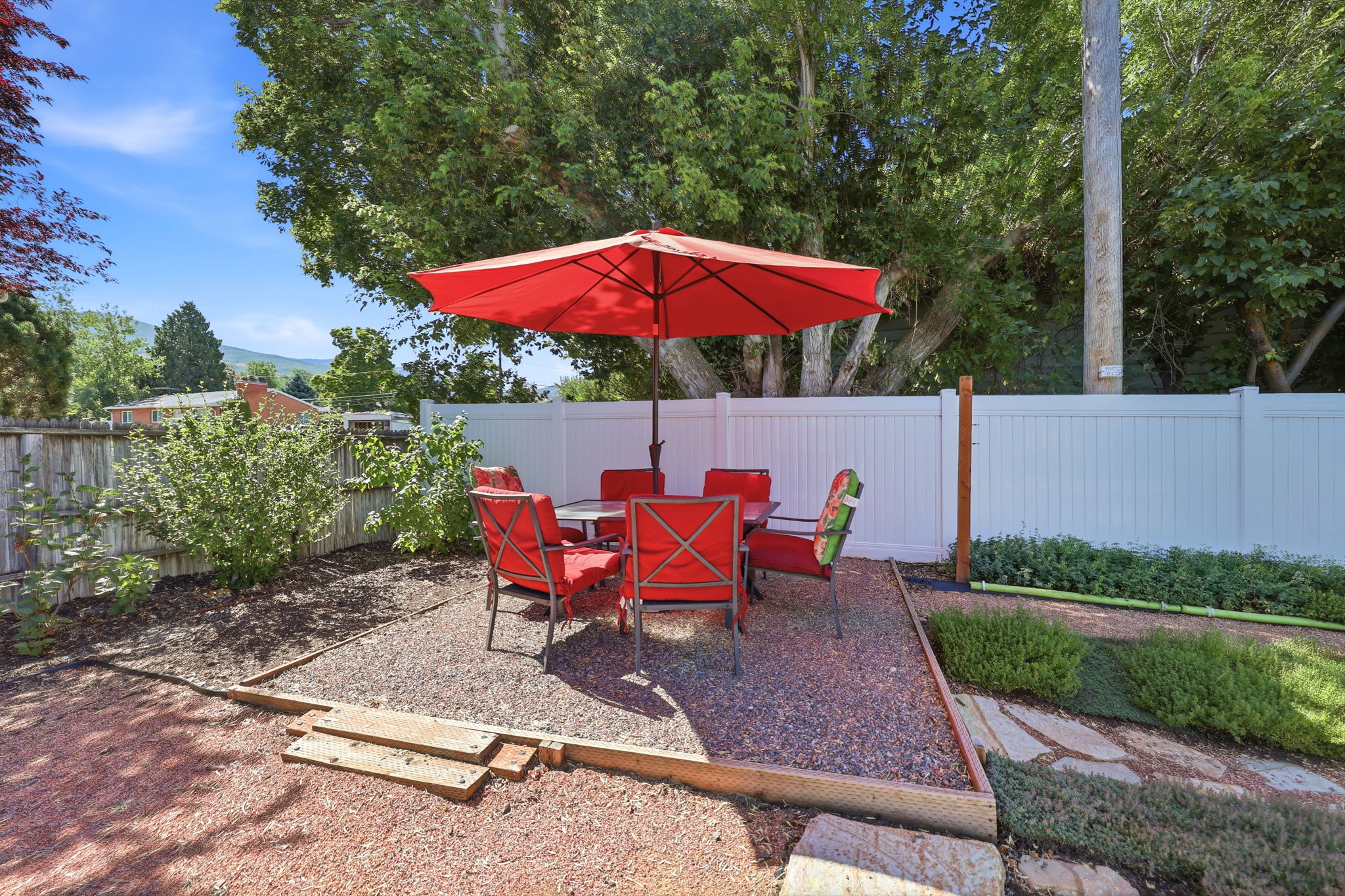 Outdoor living area featuring a gravel patio defined by timber borders