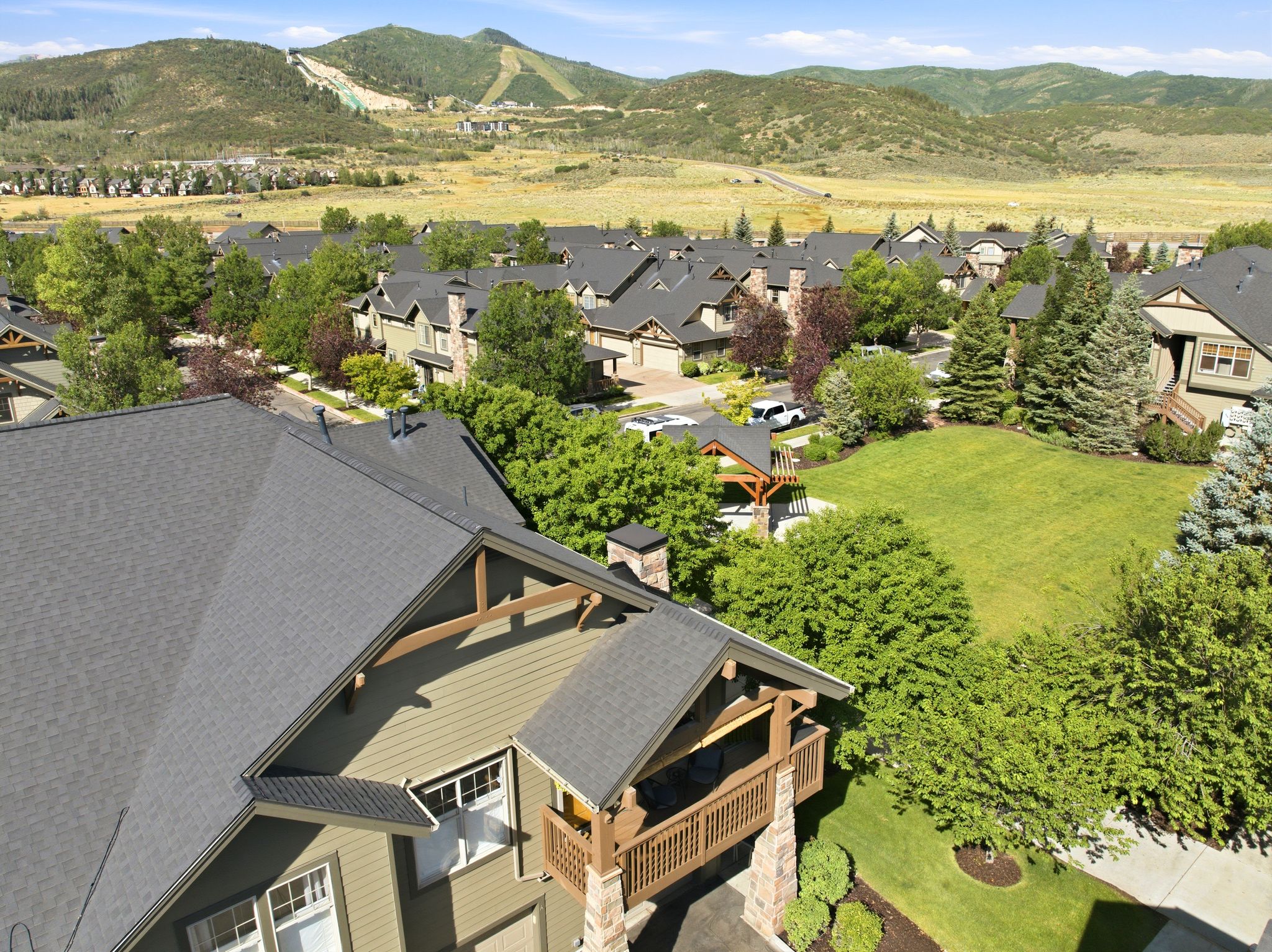 Expansive community setting with mountainous backdrop, featuring a neighborhood of residential properties