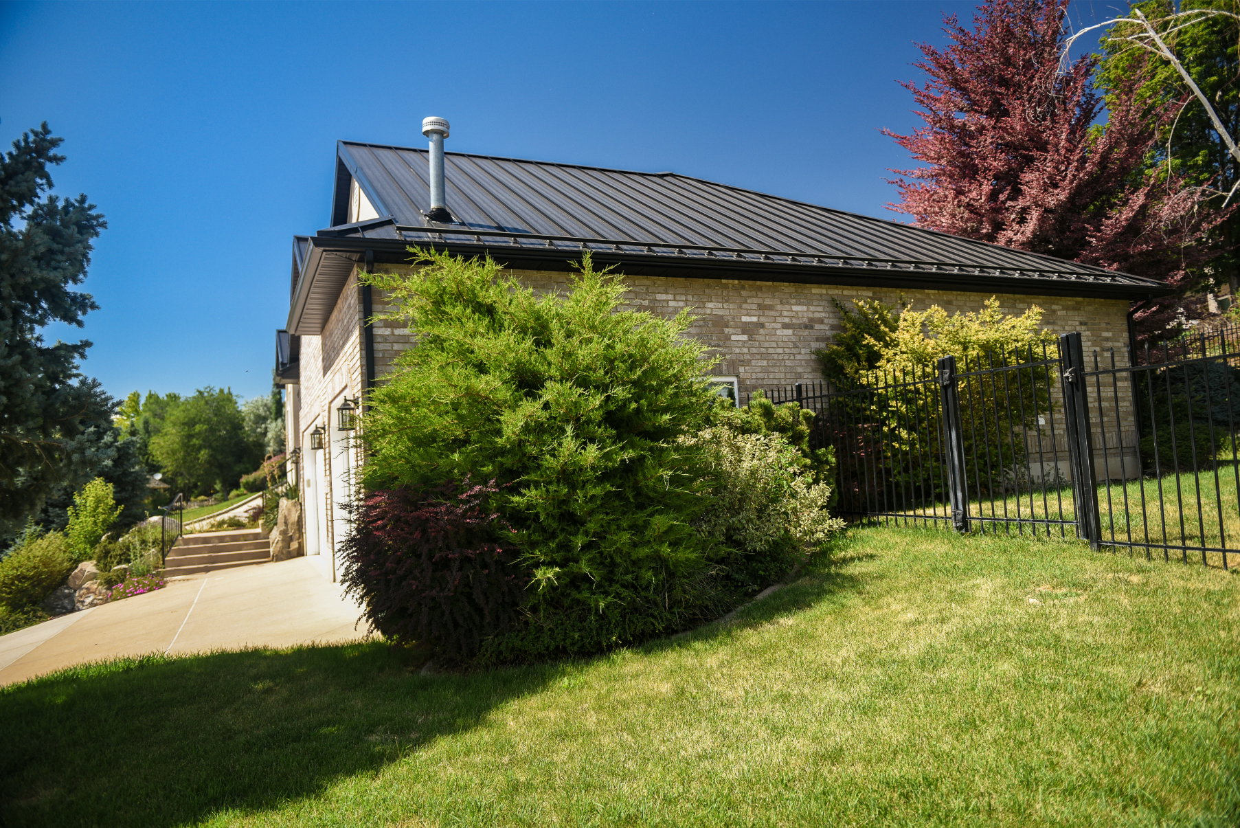 Brick-clad exterior featuring a black metal roof