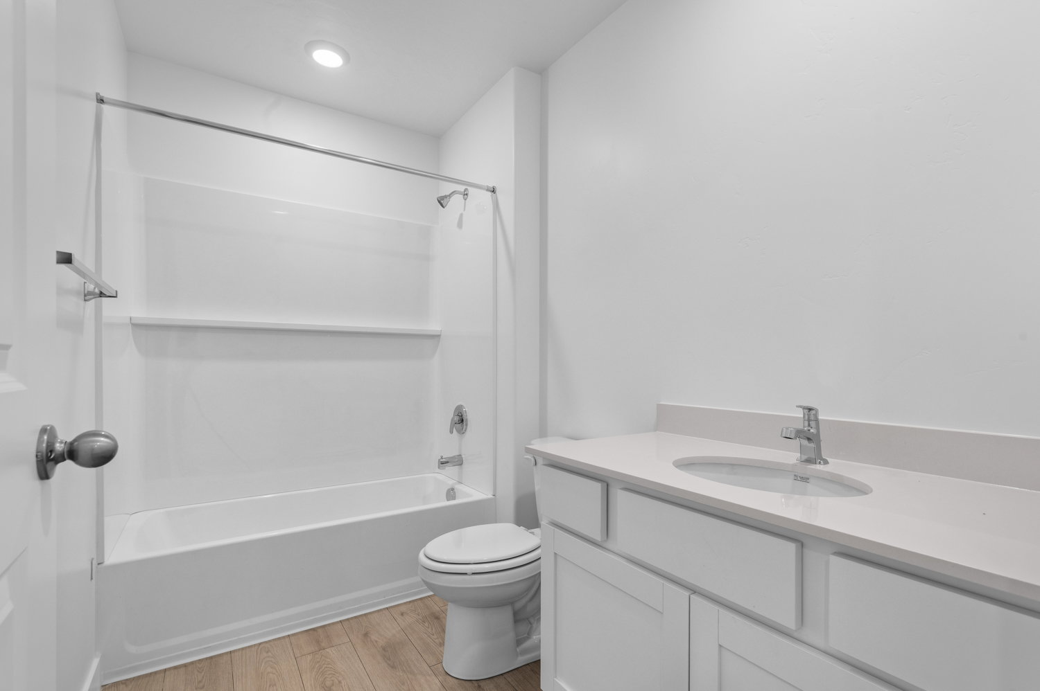 Bathroom with a white vanity featuring an integrated sink and light-toned countertop