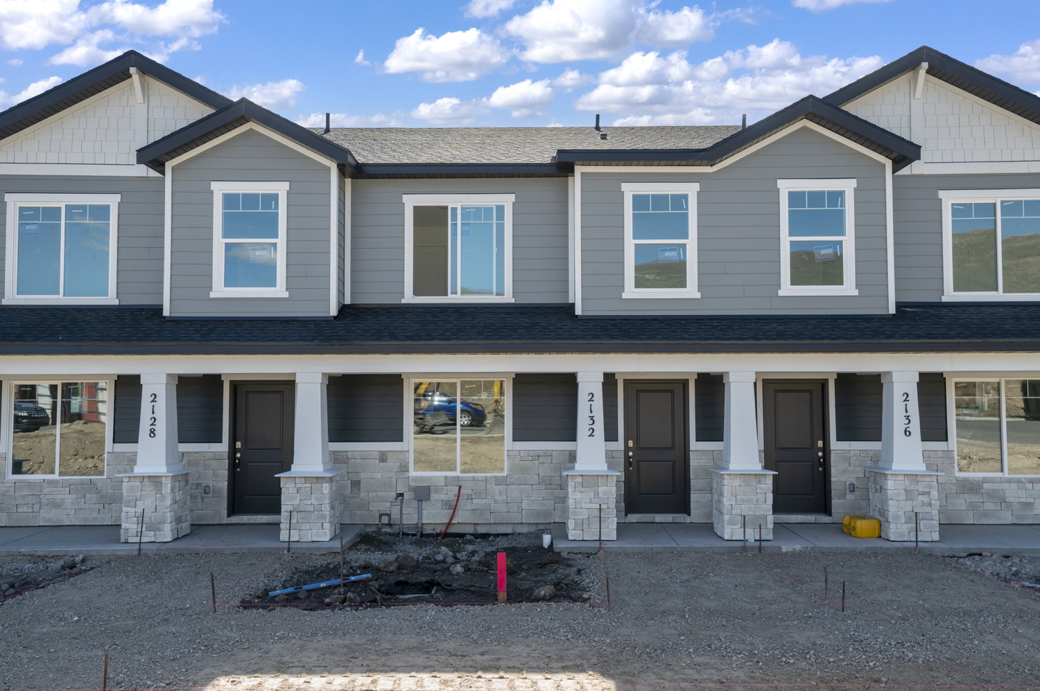Modern townhome exterior with gray siding and white trim