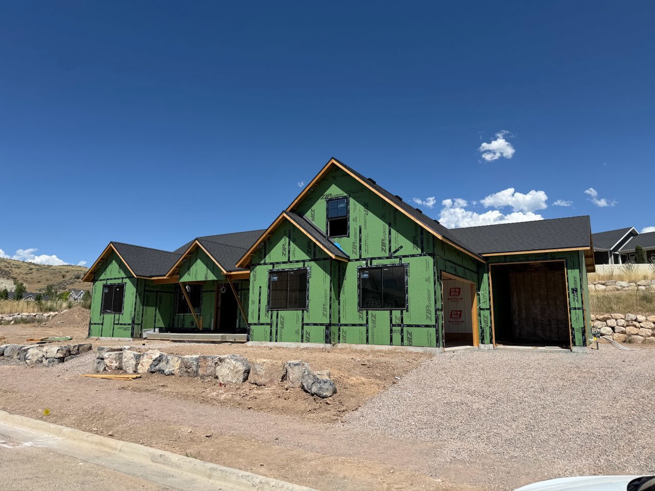 New construction residence featuring a multi-gabled roofline and a recessed entryway