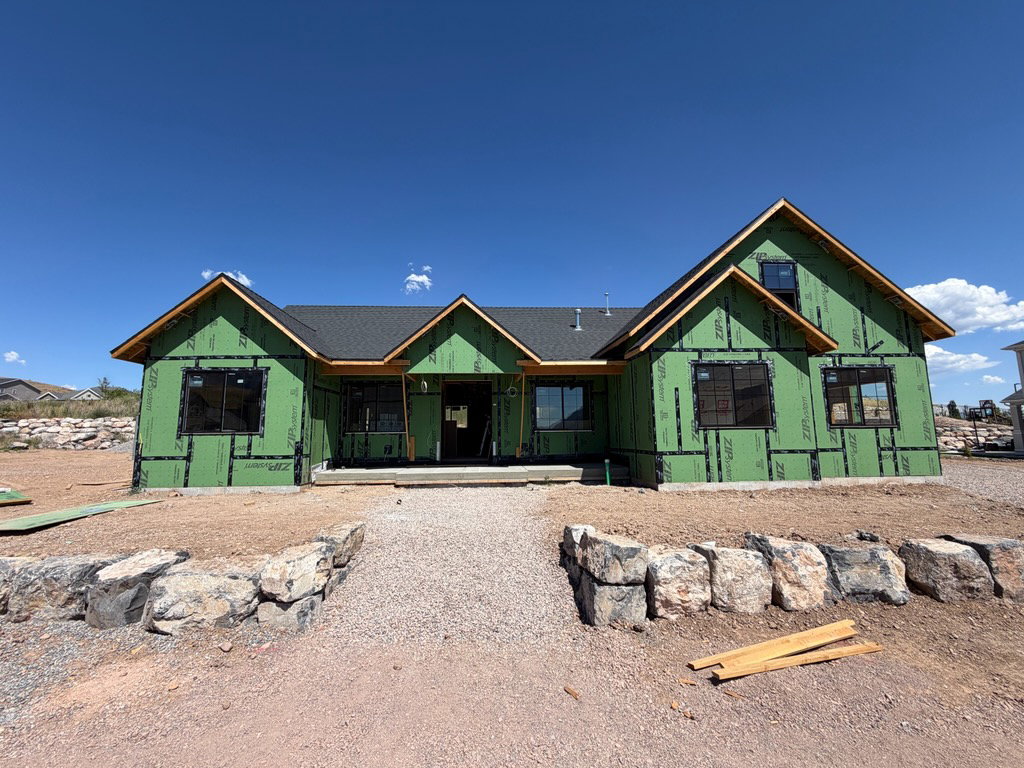 Newly constructed residence featuring a dark shingle roof and multiple gabled sections