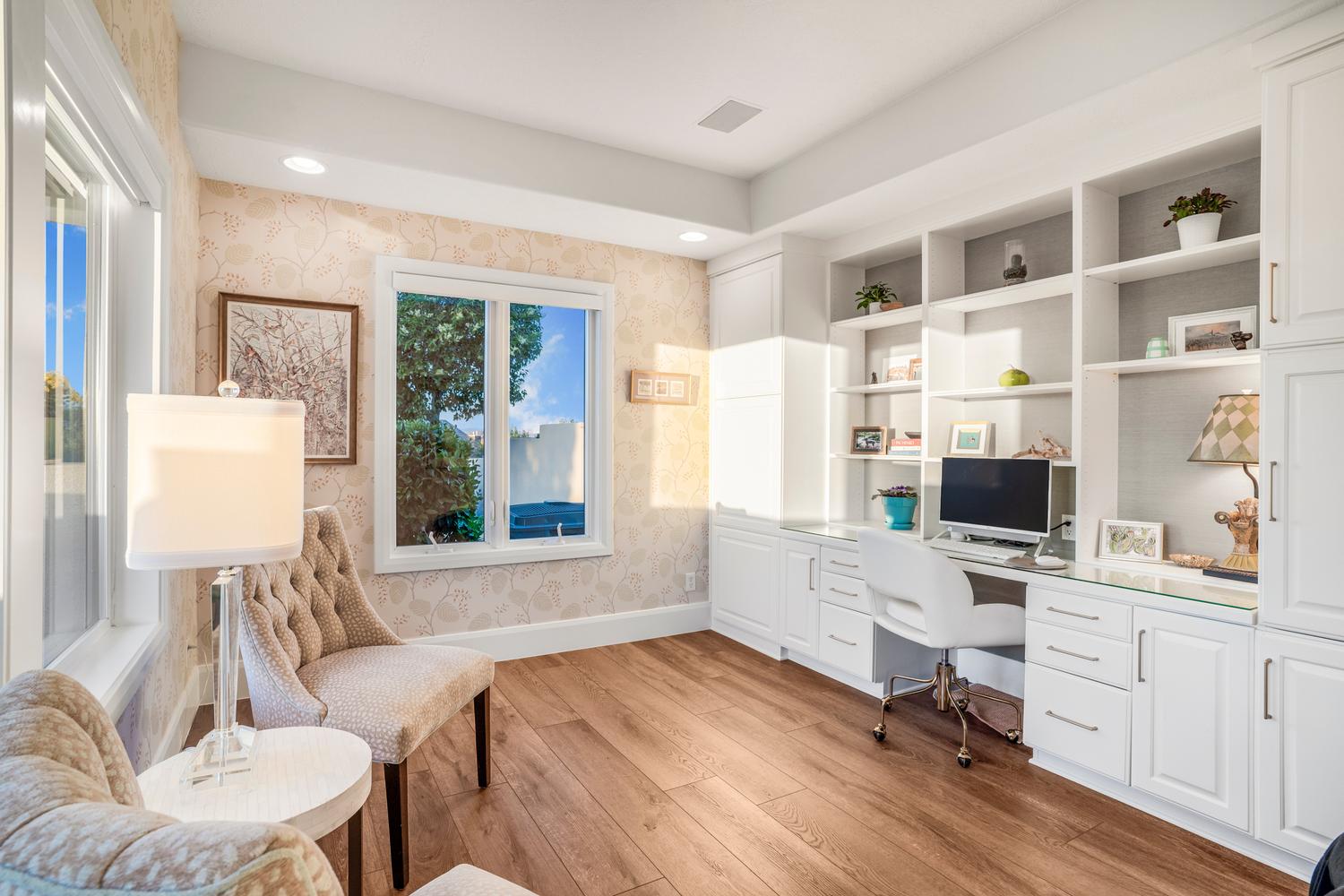 Custom built-in desk and shelving unit featuring white cabinetry