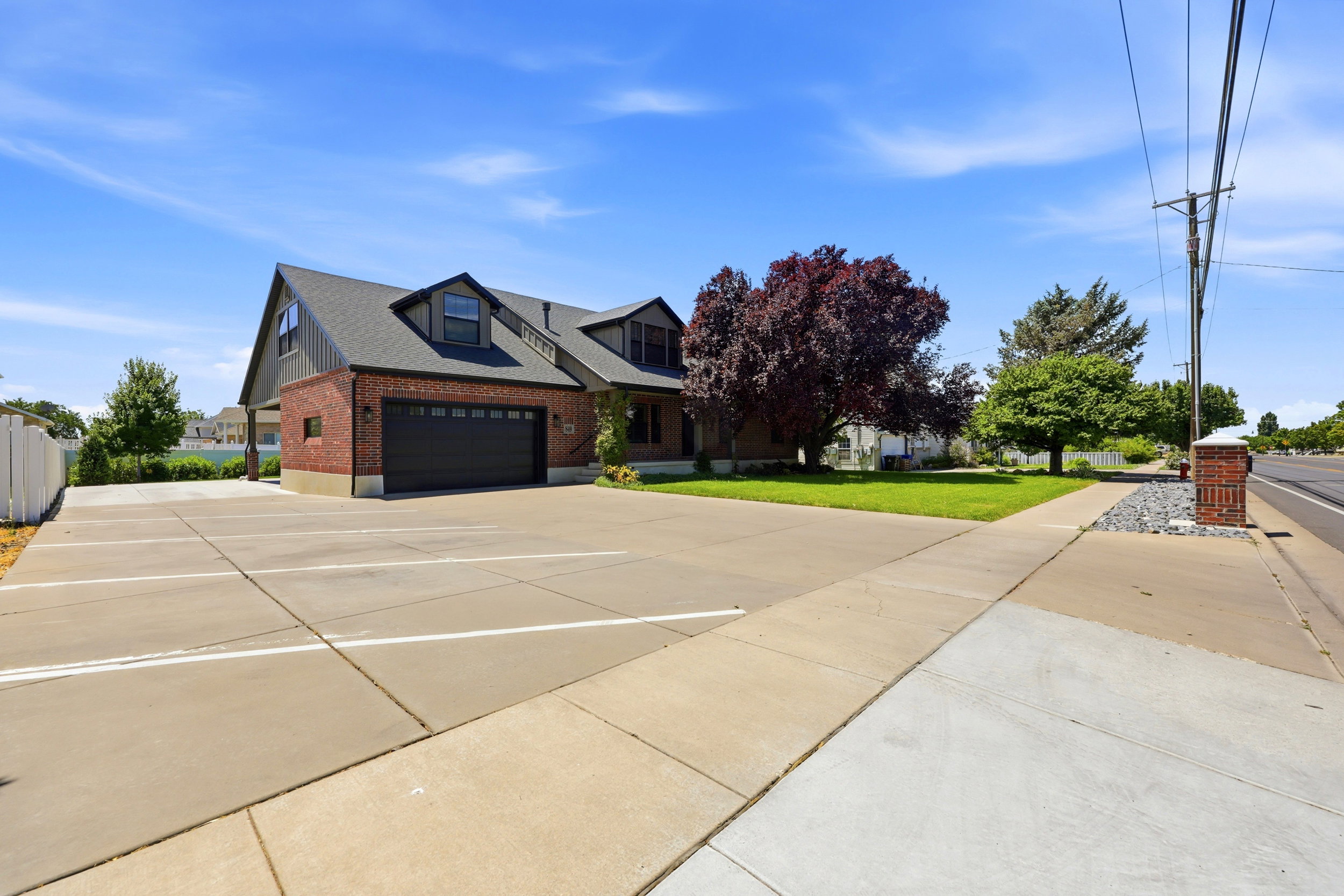 Expansive paved parking area with marked spaces and a concrete sidewalk