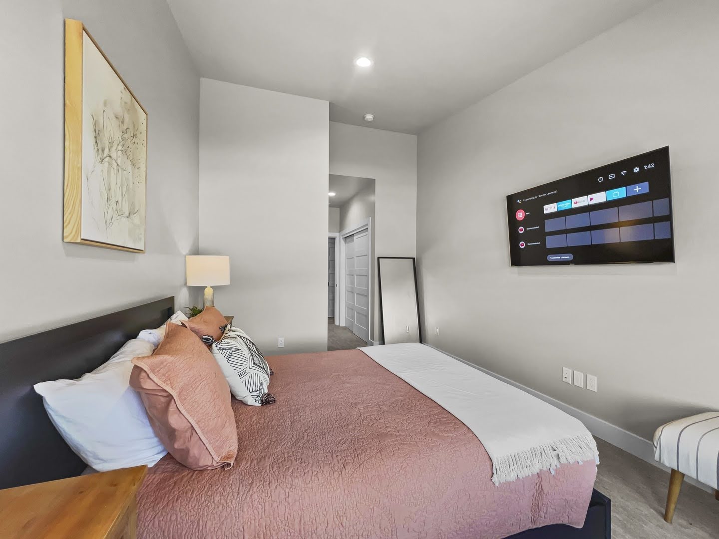 Bedroom with light gray walls, recessed lighting, and wood-finish flooring