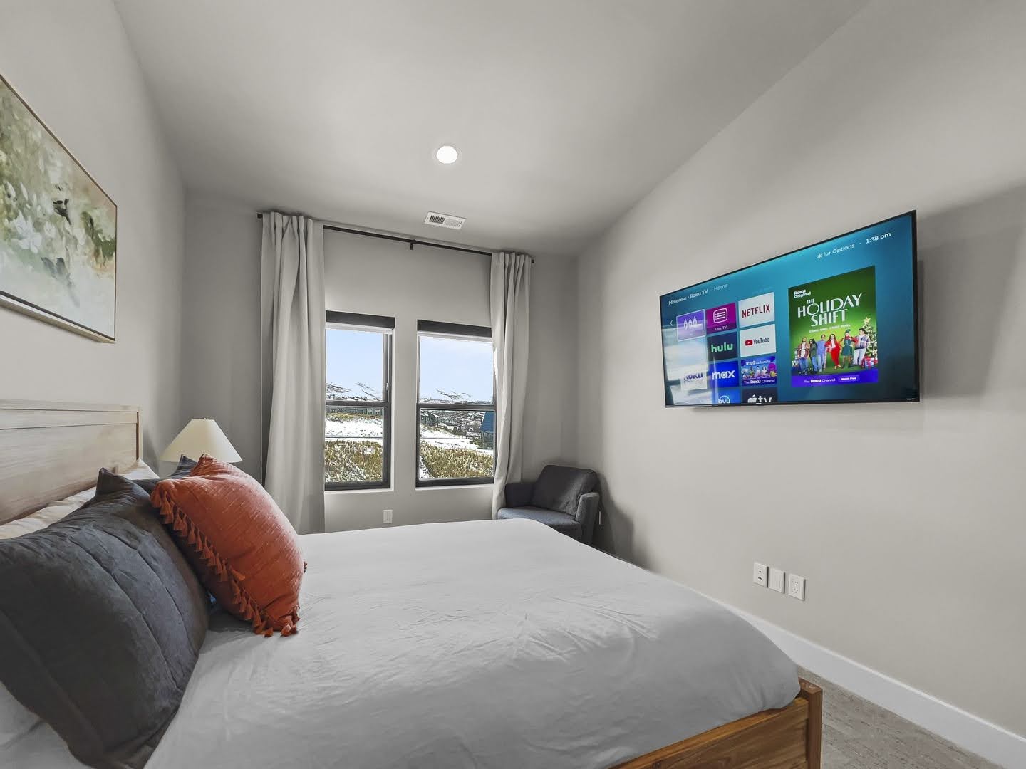Bedroom featuring neutral wall colors, carpet flooring, a recessed ceiling light, and windows showcasing a distant mountain landscape