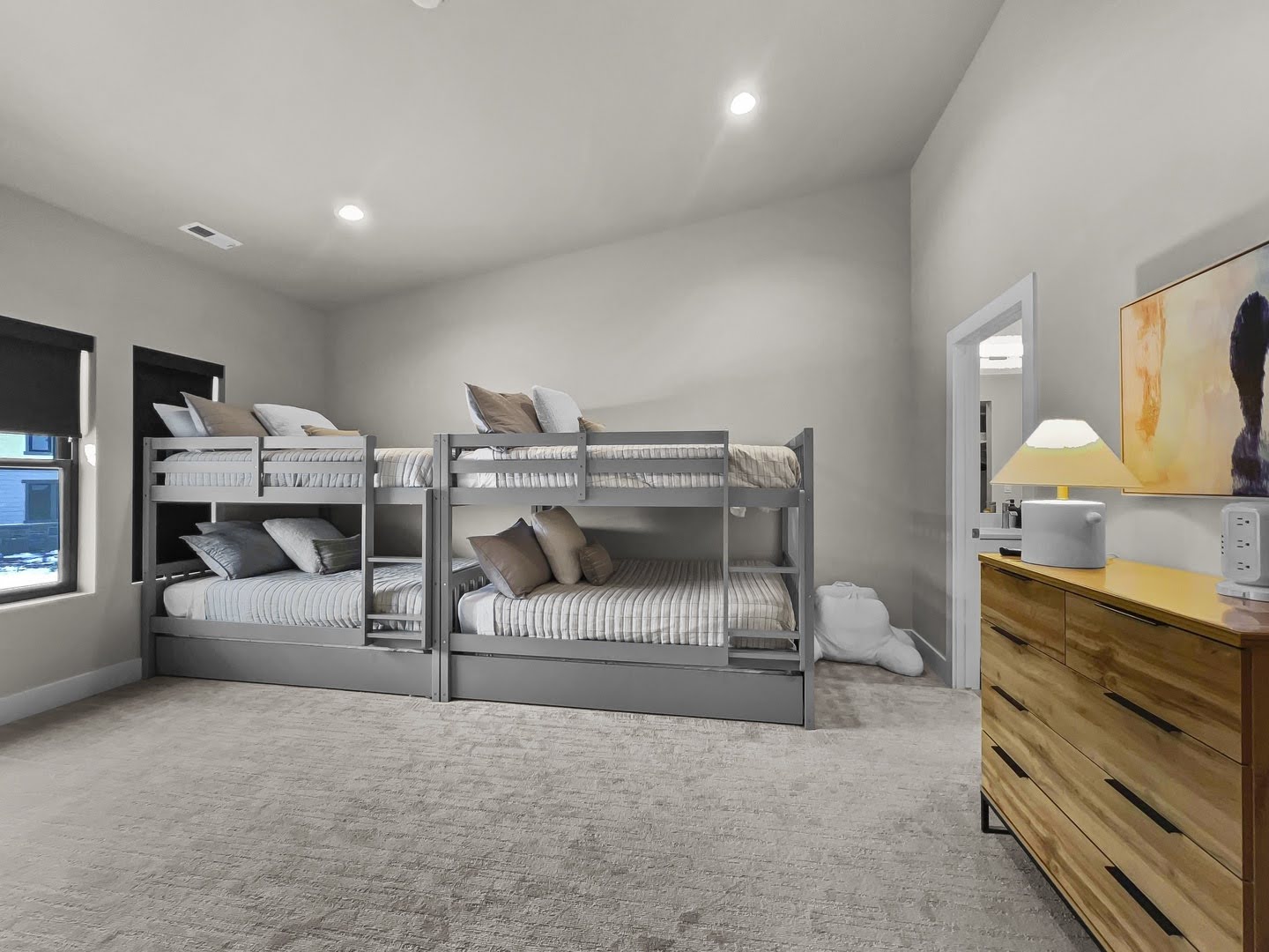 Spacious room featuring light-colored carpet flooring and recessed ceiling lighting