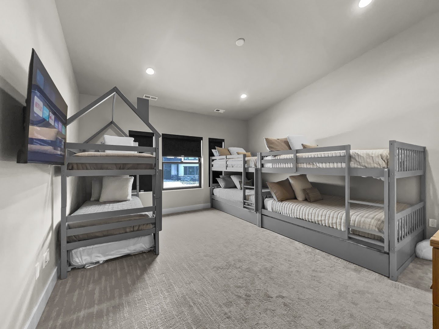 Spacious room featuring light gray walls, recessed lighting, and soft carpet flooring