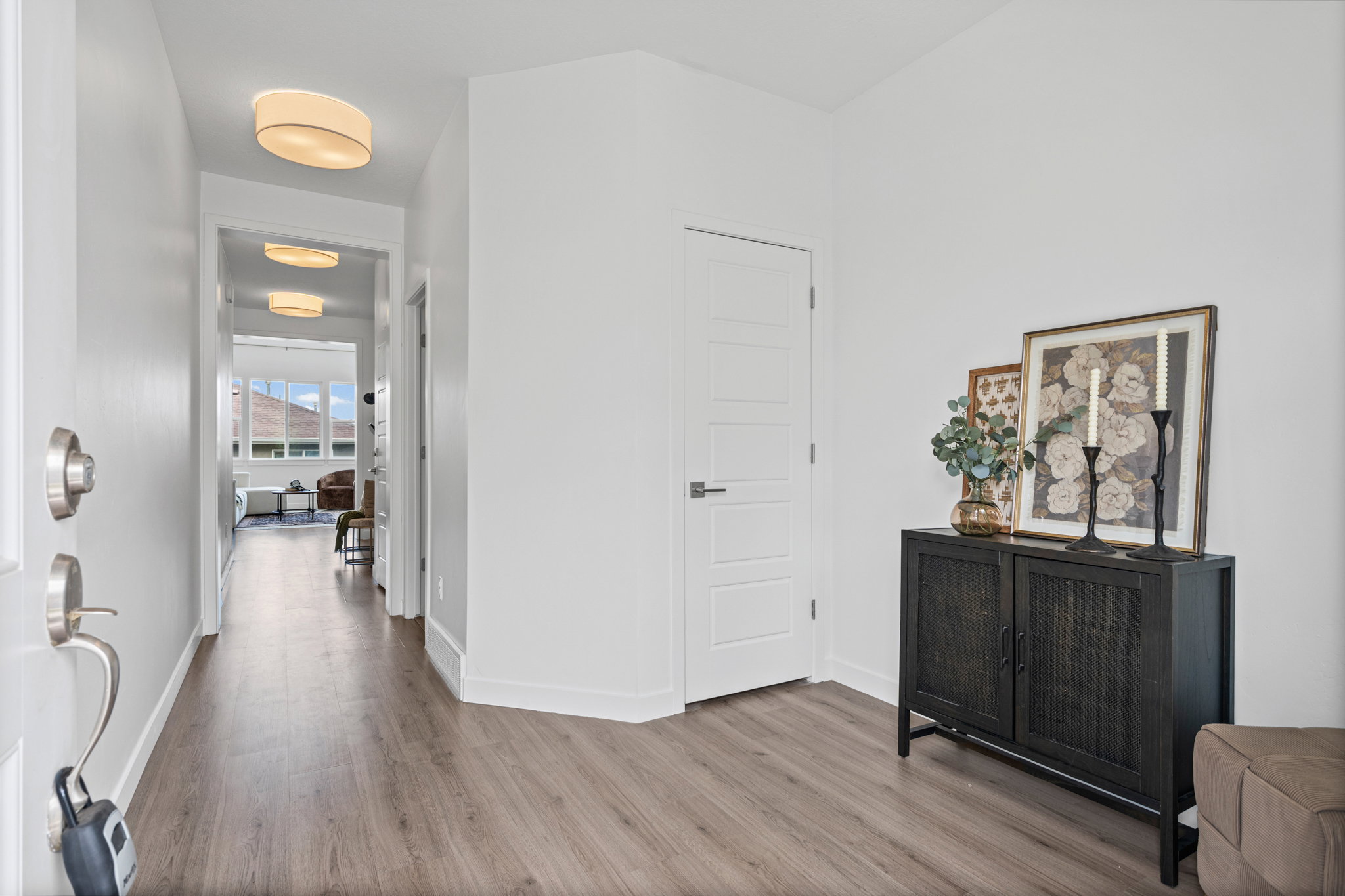 Entryway featuring wood-finish flooring and white baseboards
