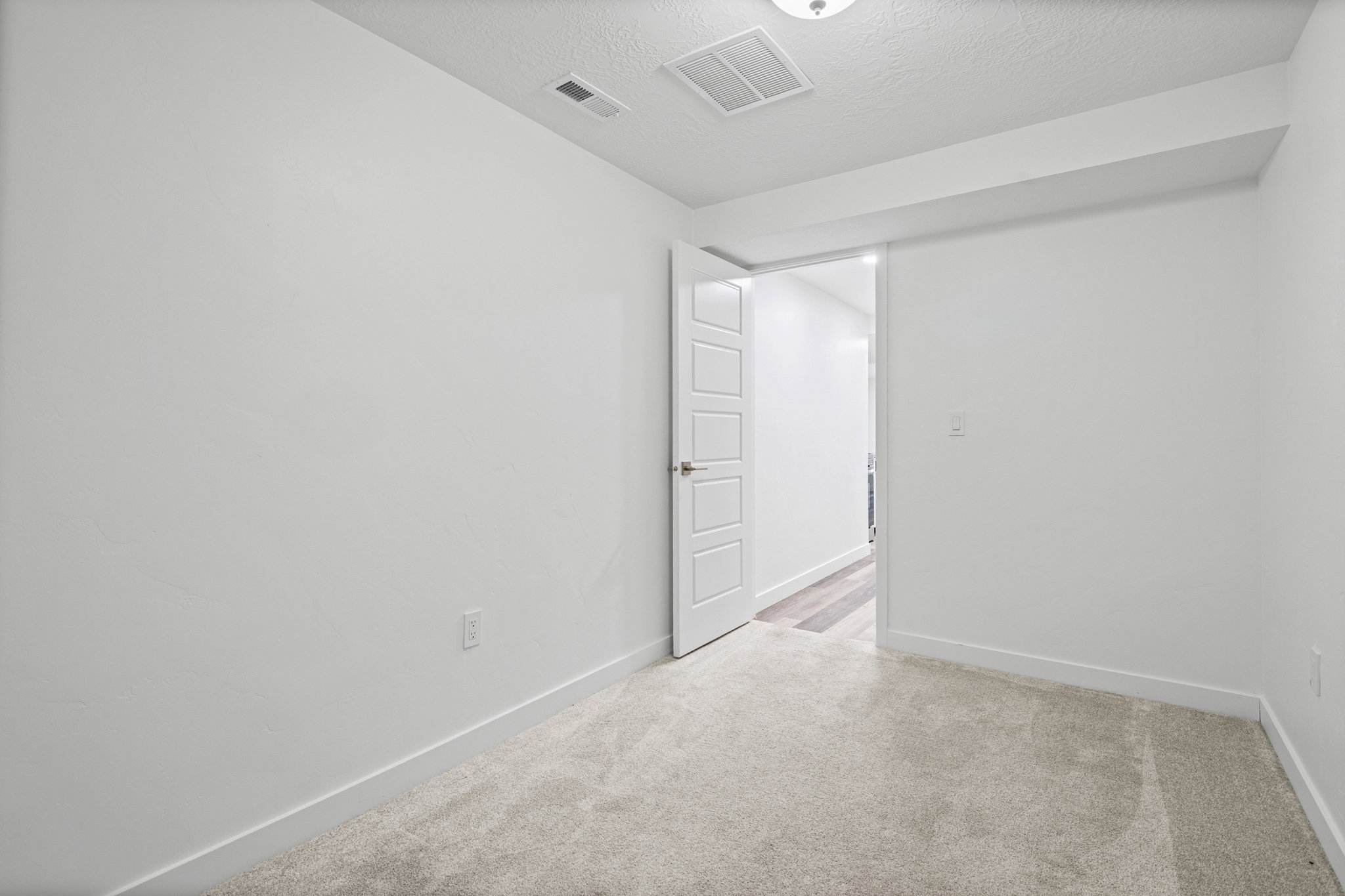 Neutral-toned carpeting paired with white walls