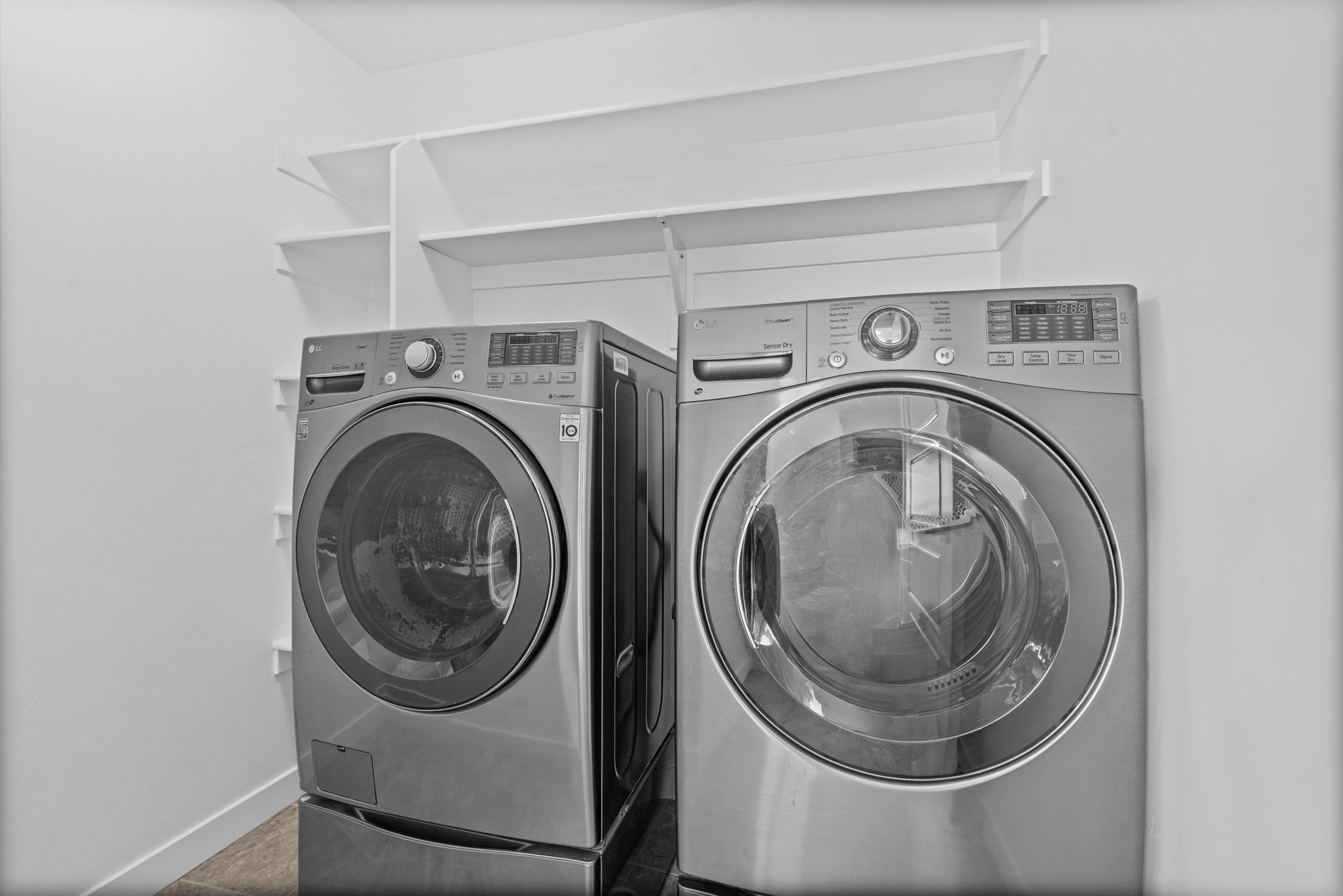 Dedicated laundry area featuring a front-loading washer and dryer set
