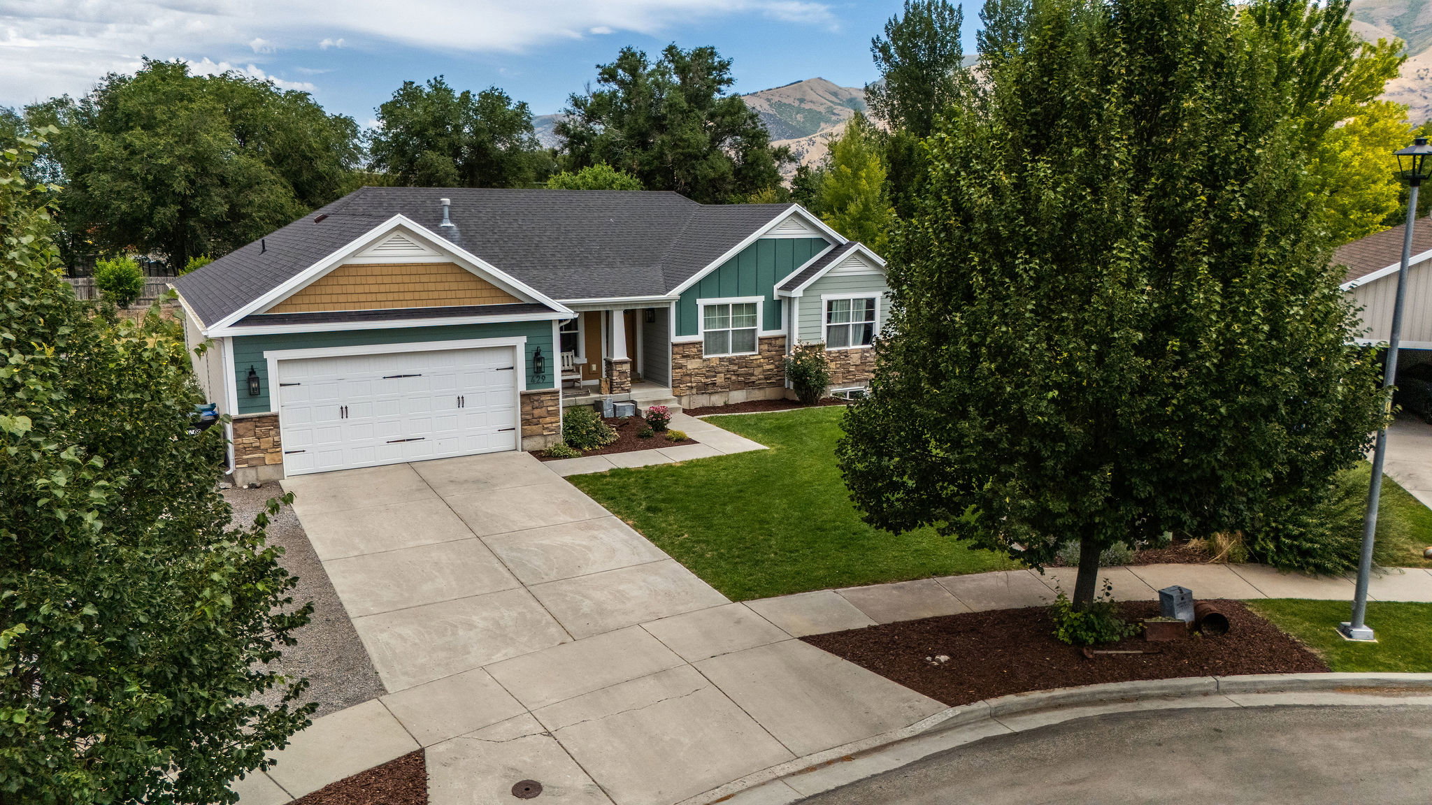 Contemporary exterior featuring a stone and siding facade with shingle accents